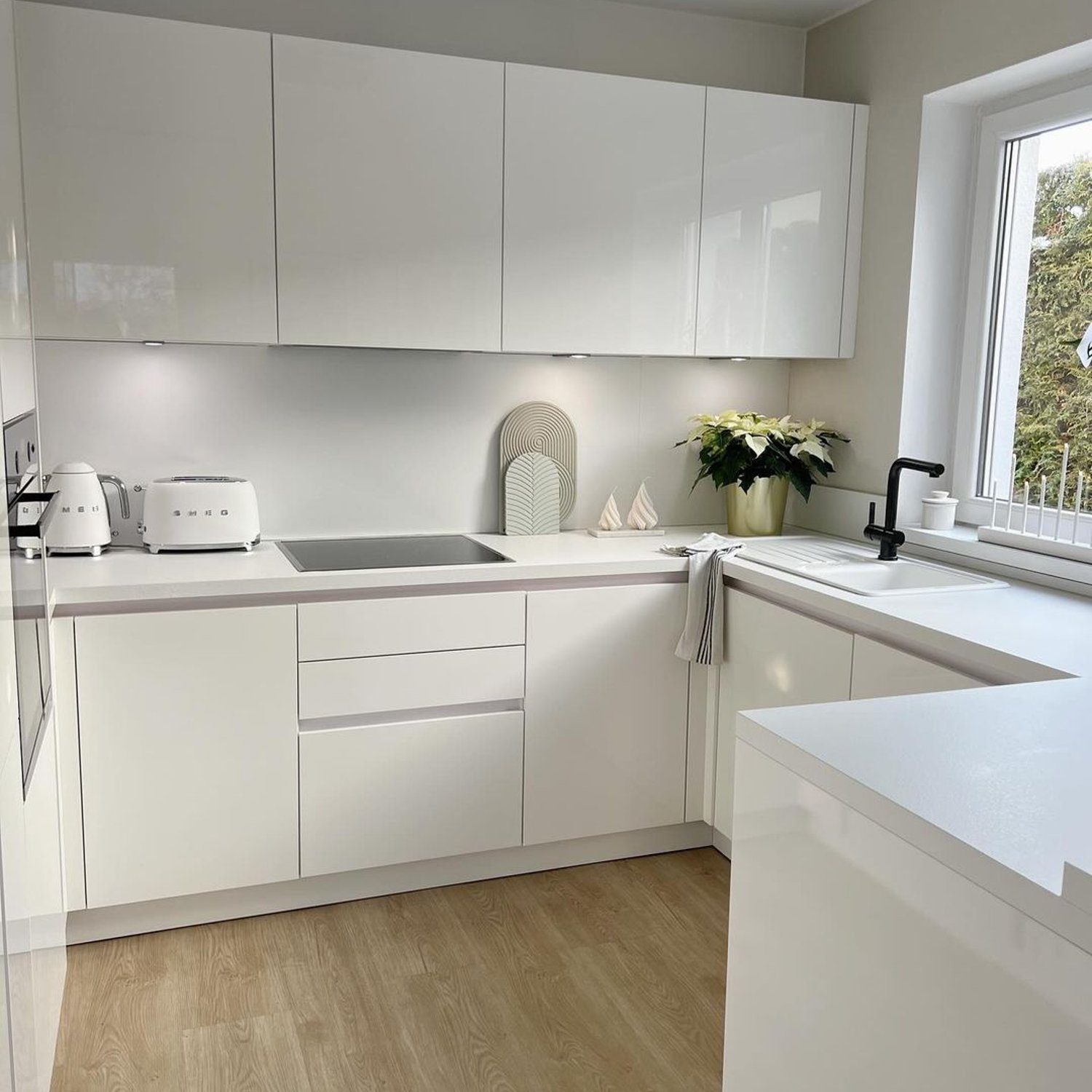 A minimalist white kitchen with sleek lines and modern appliances