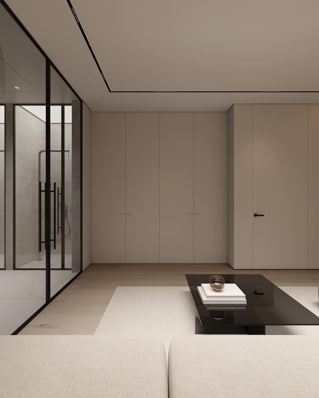 A modern minimalistic living room featuring seamless built-in cabinets and a striking black glass coffee table