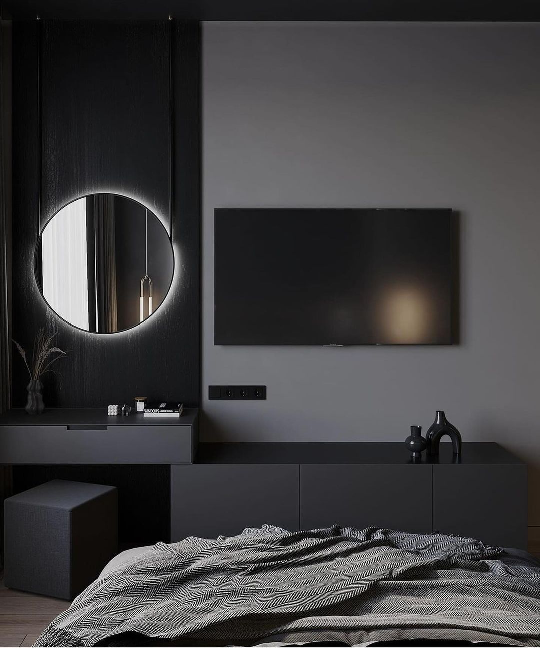 A modern bedroom featuring a minimalist black and gray color scheme