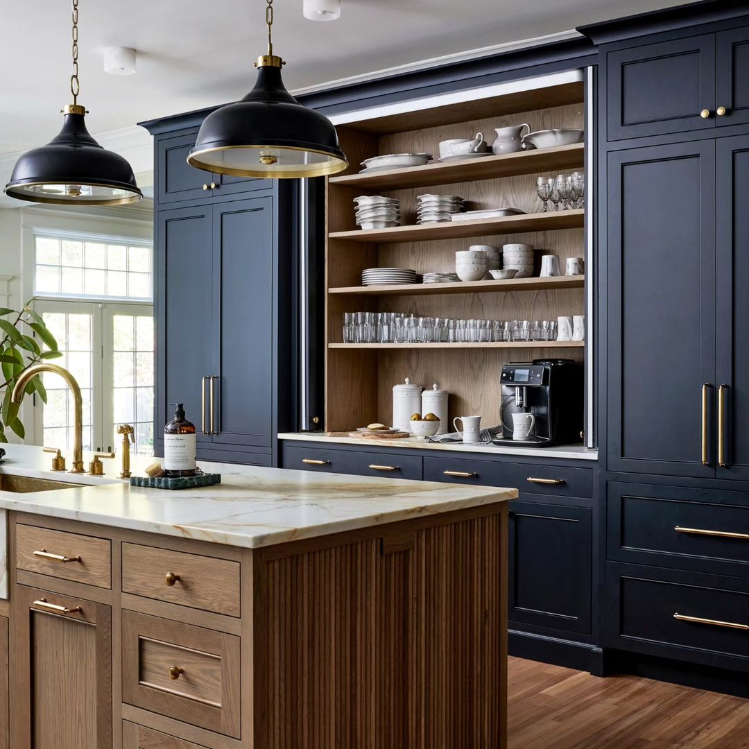 Chic modern kitchen with navy blue cabinets and brass accents