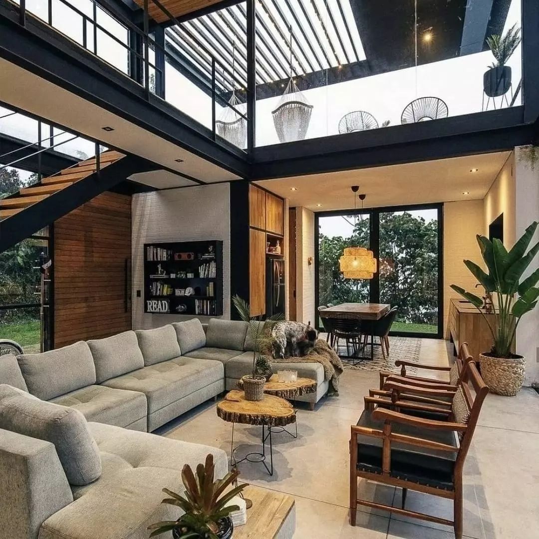 A modern open-plan living space with high ceilings and abundant natural light