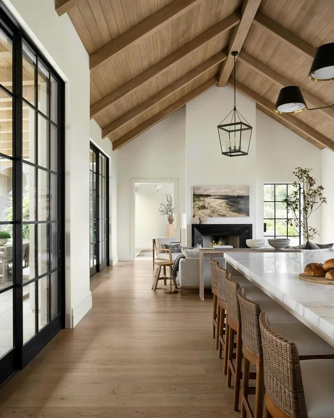 A harmonious blend of natural light and earthy materials in an open-plan living space.