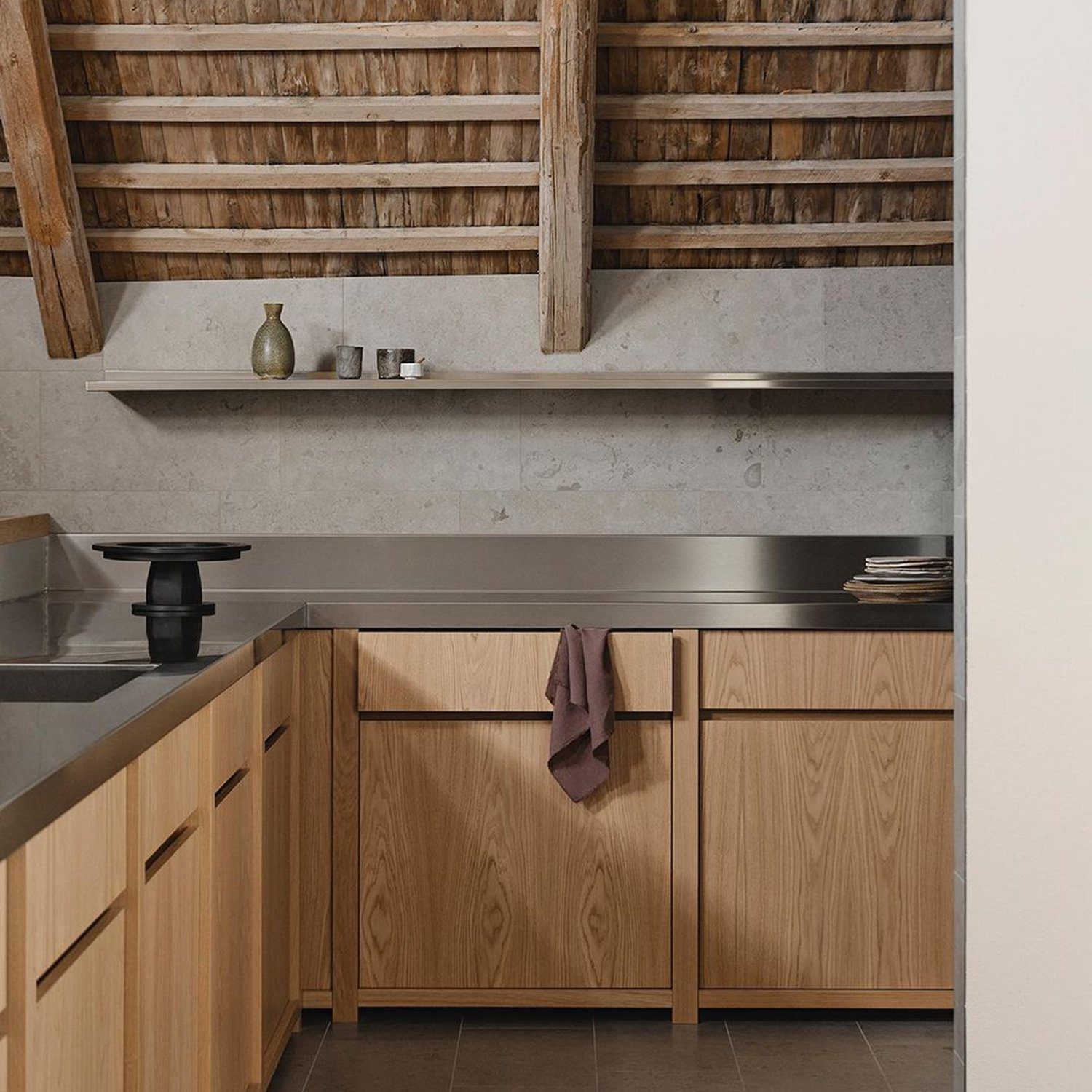 A modern kitchen with exposed wooden beams