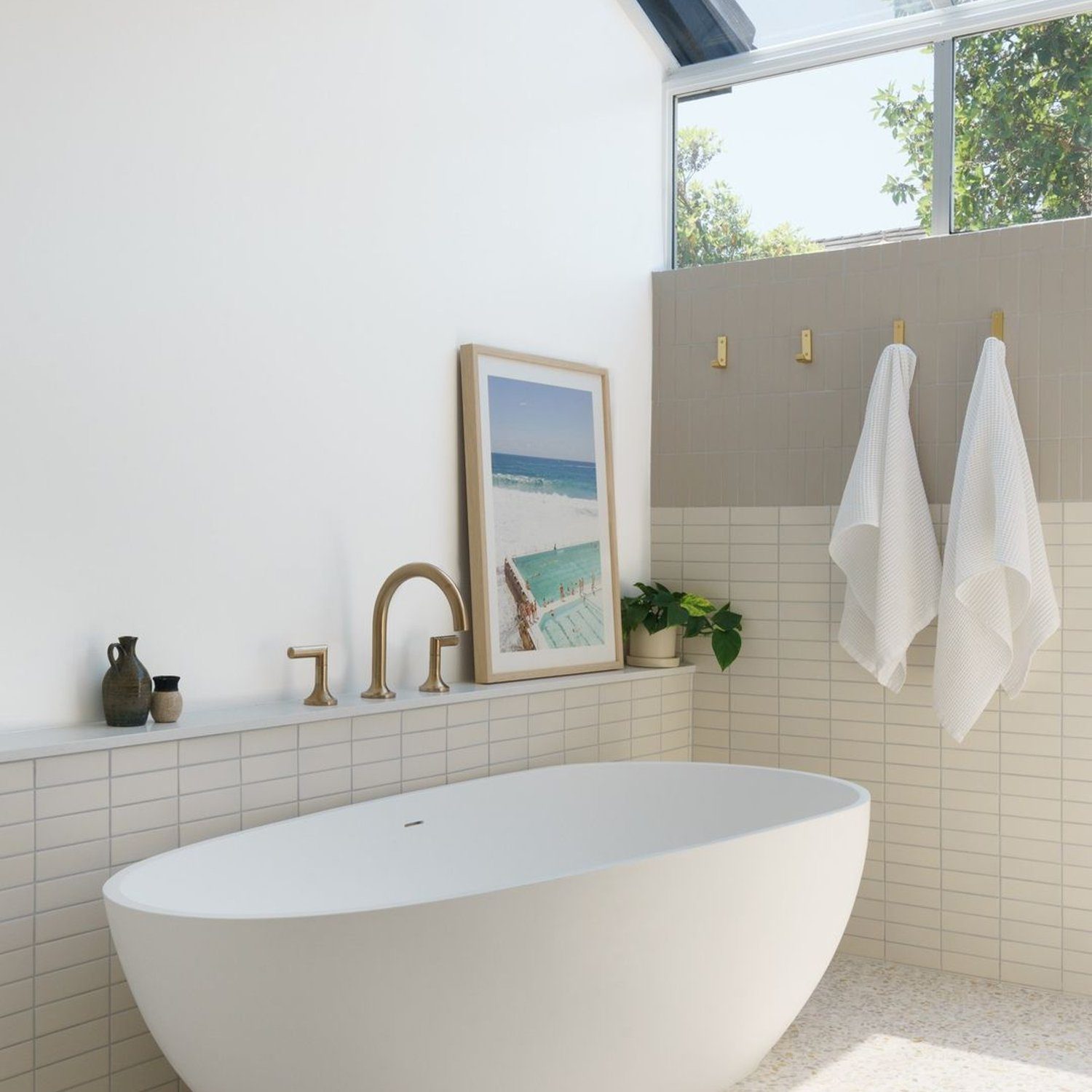 A modern and serene bathroom featuring a freestanding tub