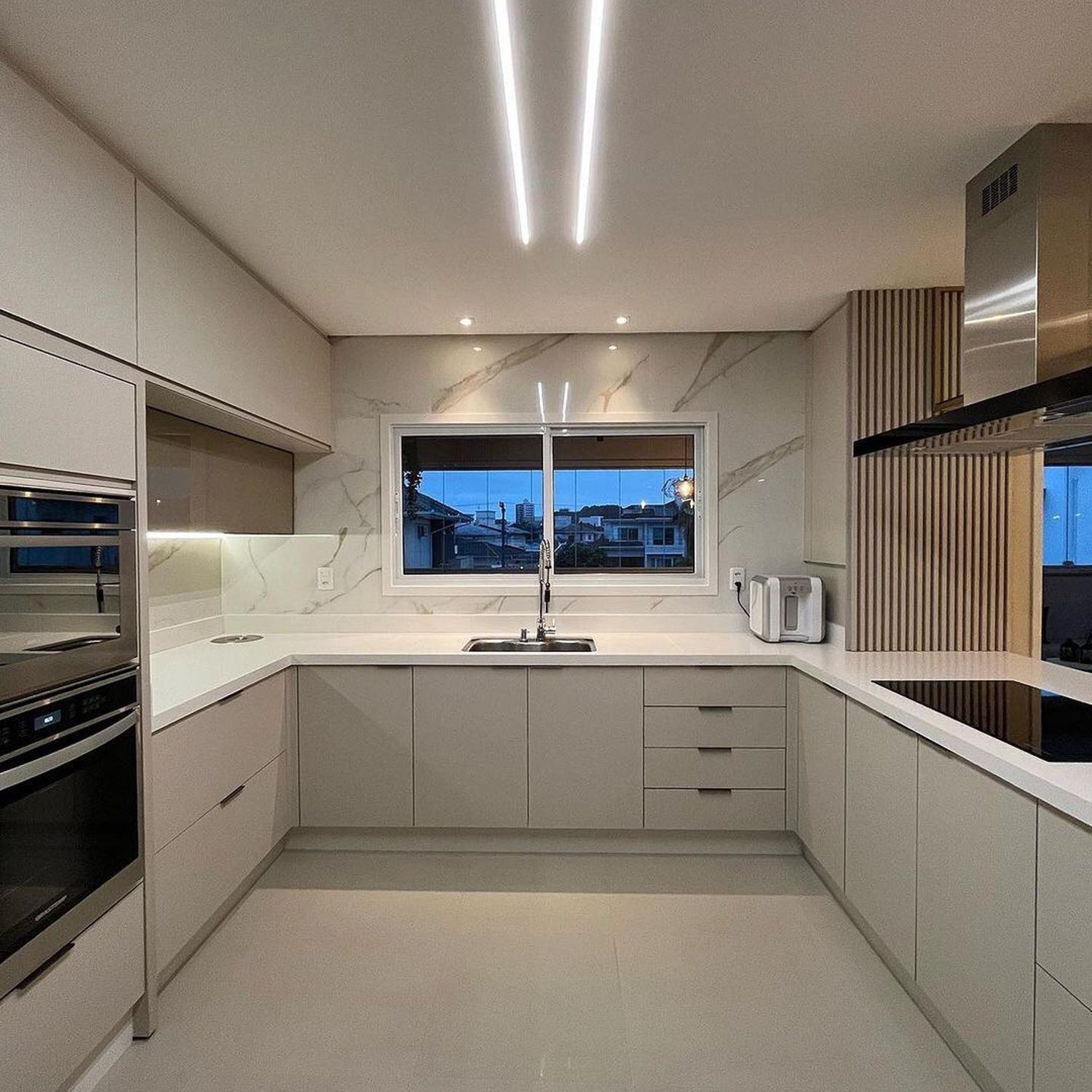 A modern kitchen with sleek design features and ambient lighting