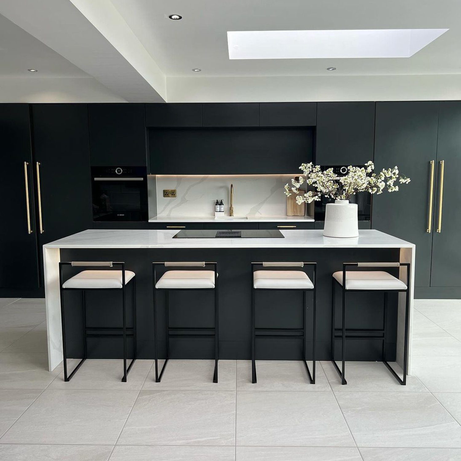 A modern, sophisticated kitchen with clean lines and a monochromatic color palette