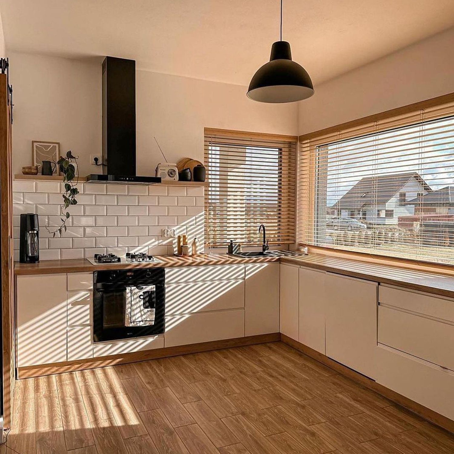 A modern, sunlit kitchen with sleek finishes