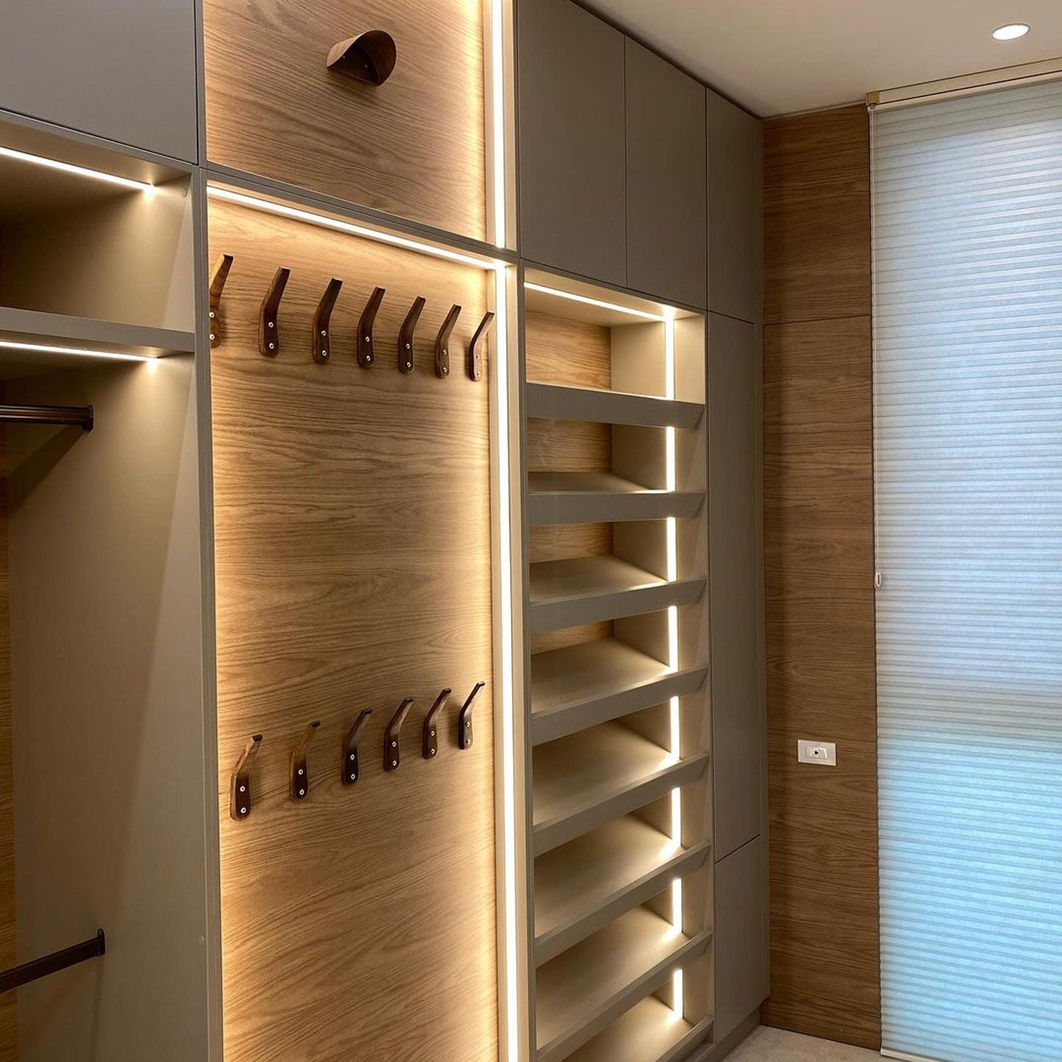 A neatly organized walk-in closet with LED lighting accents