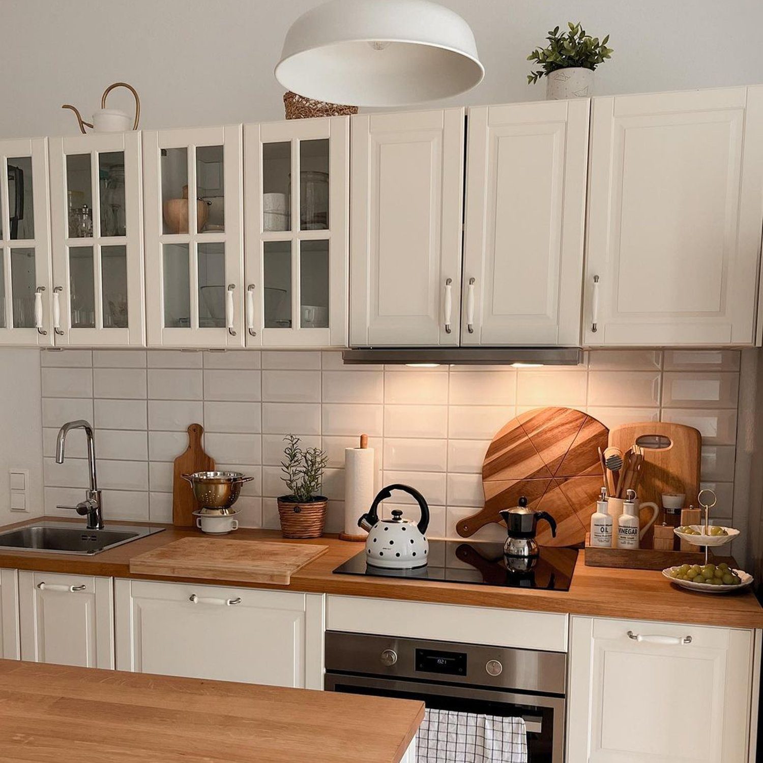 A neatly organized kitchen with white cabinetry and modern appliances