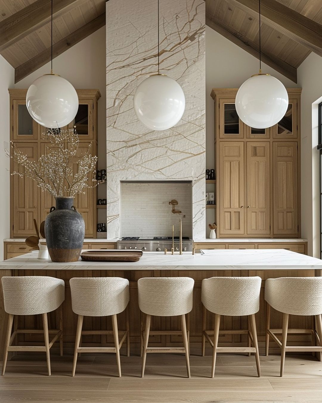 A modern kitchen design featuring light wood tones and white surfaces