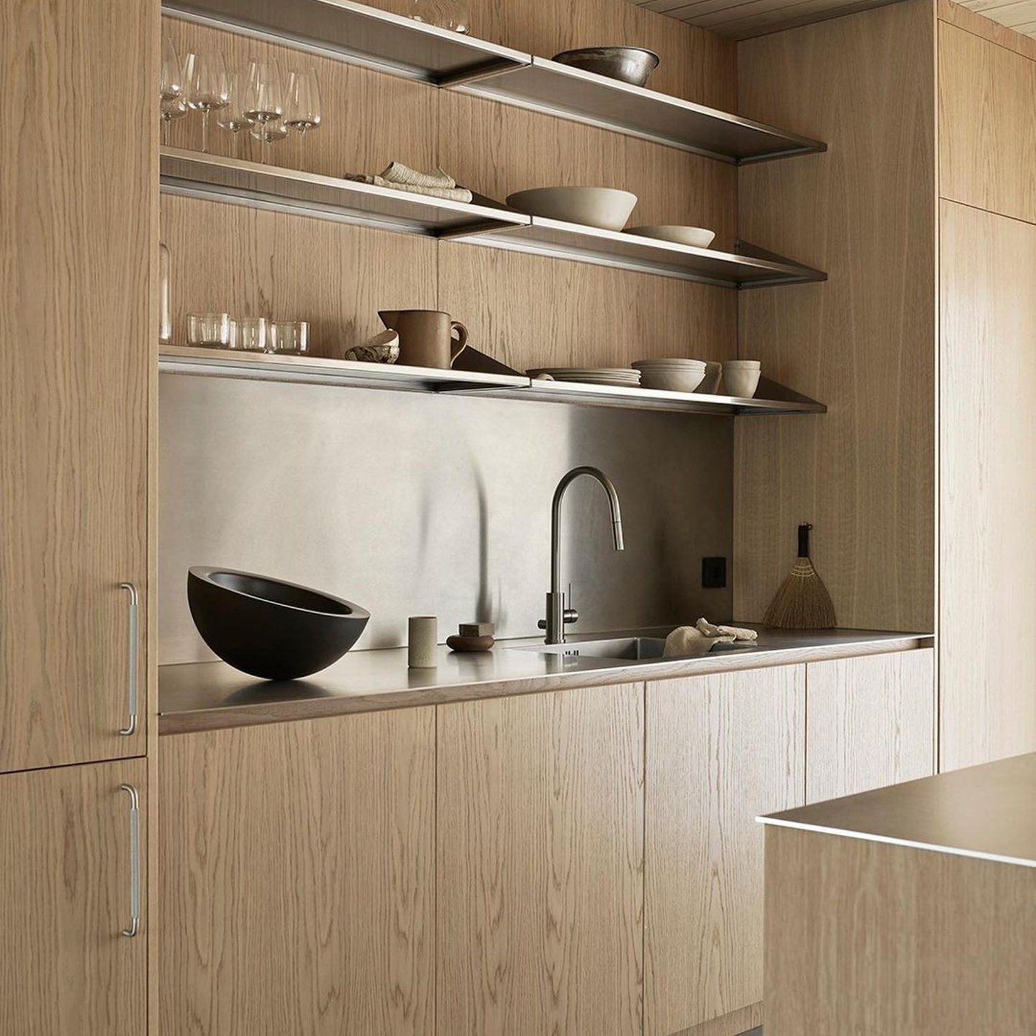 A minimalist kitchen with natural wood finishes and sleek design elements