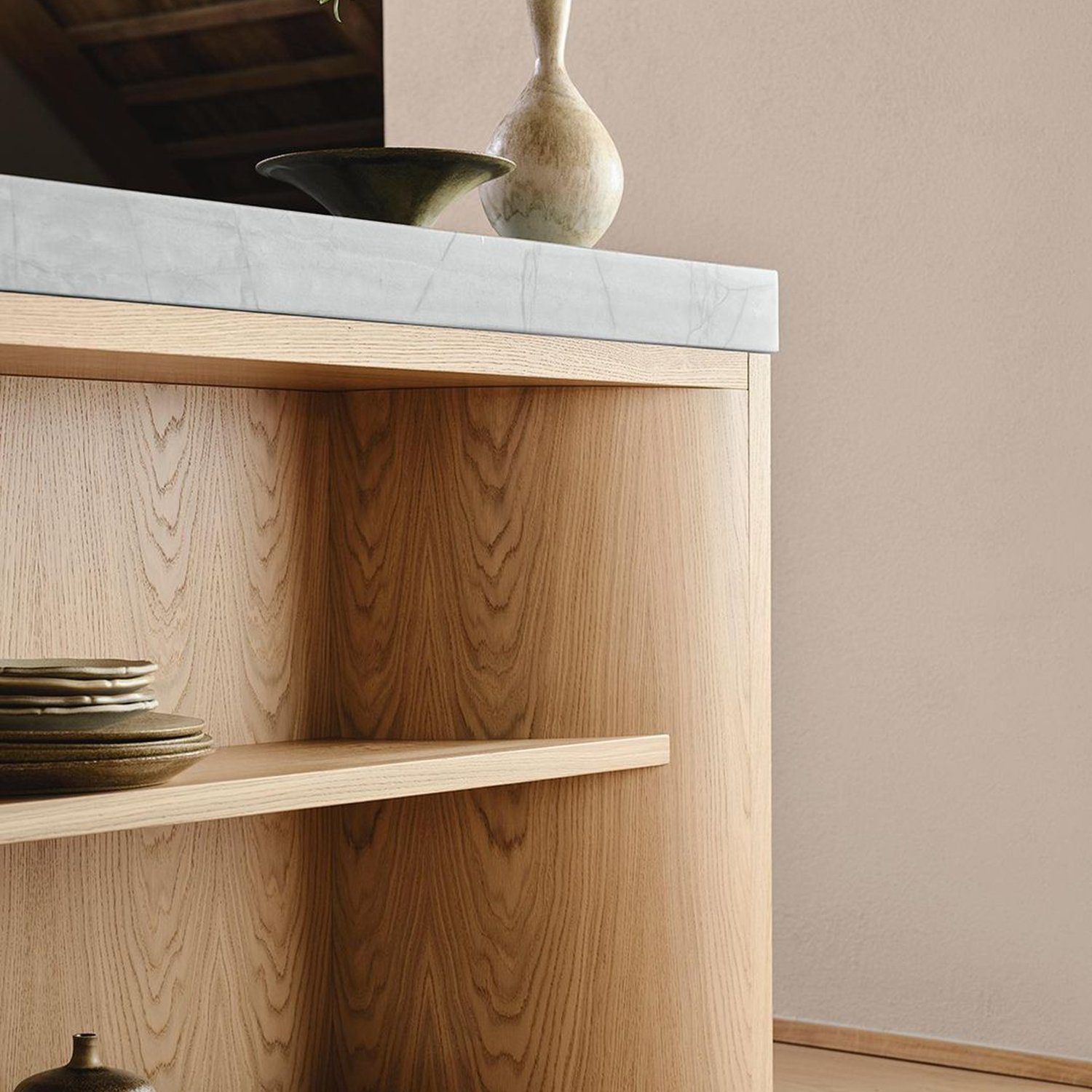 An elegantly crafted wooden sideboard featuring a marble top, with artistic pottery and bowls on display.