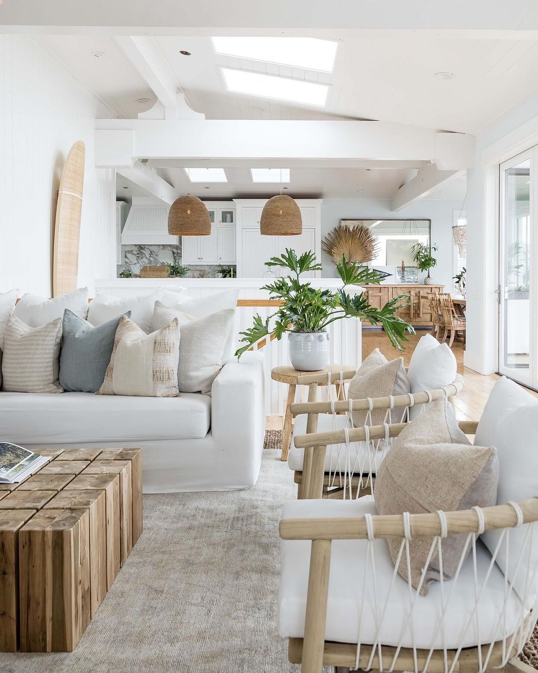 Coastal-inspired open space living area with skylights and textured decor