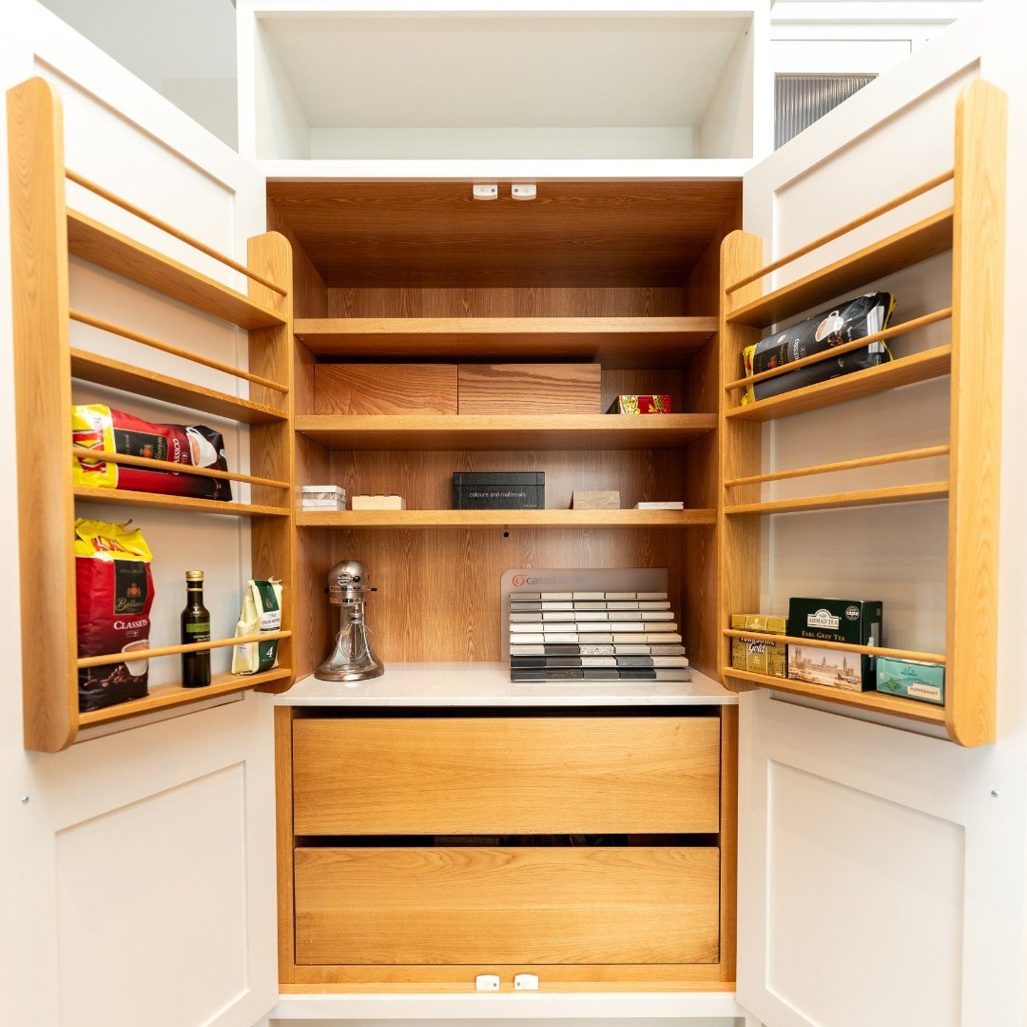 A neatly organized pantry with contemporary wooden shelving