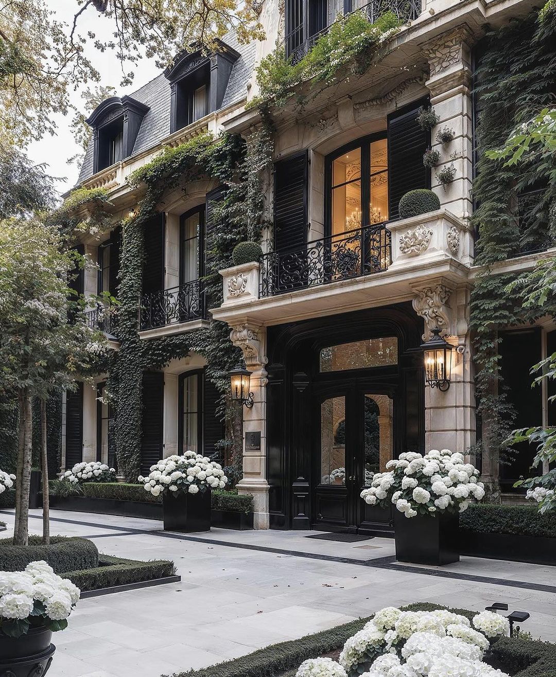 A sophisticated Parisian-style townhouse facade with lush greenery and immaculate white hydrangeas