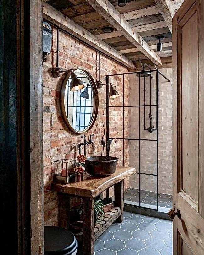 A rustic-chic bathroom featuring exposed brick walls and wooden beams