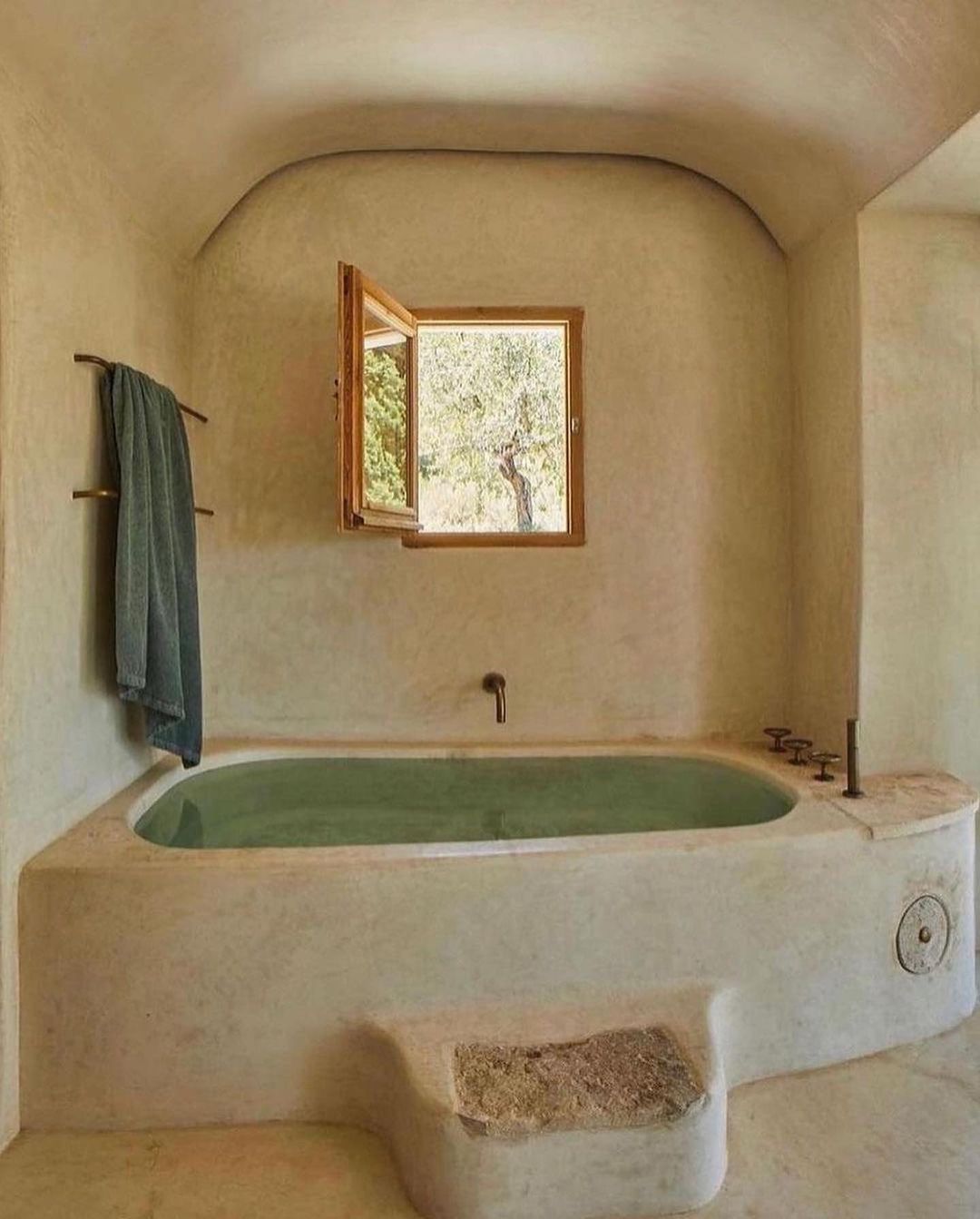 Rustic-inspired bathroom with a built-in bathtub overlooking nature