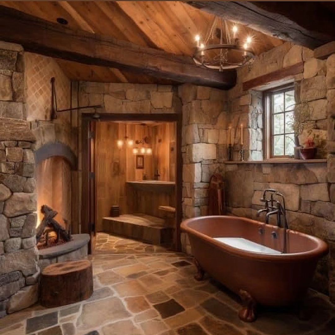 A rustic bathroom featuring a stone hearth and a freestanding copper tub