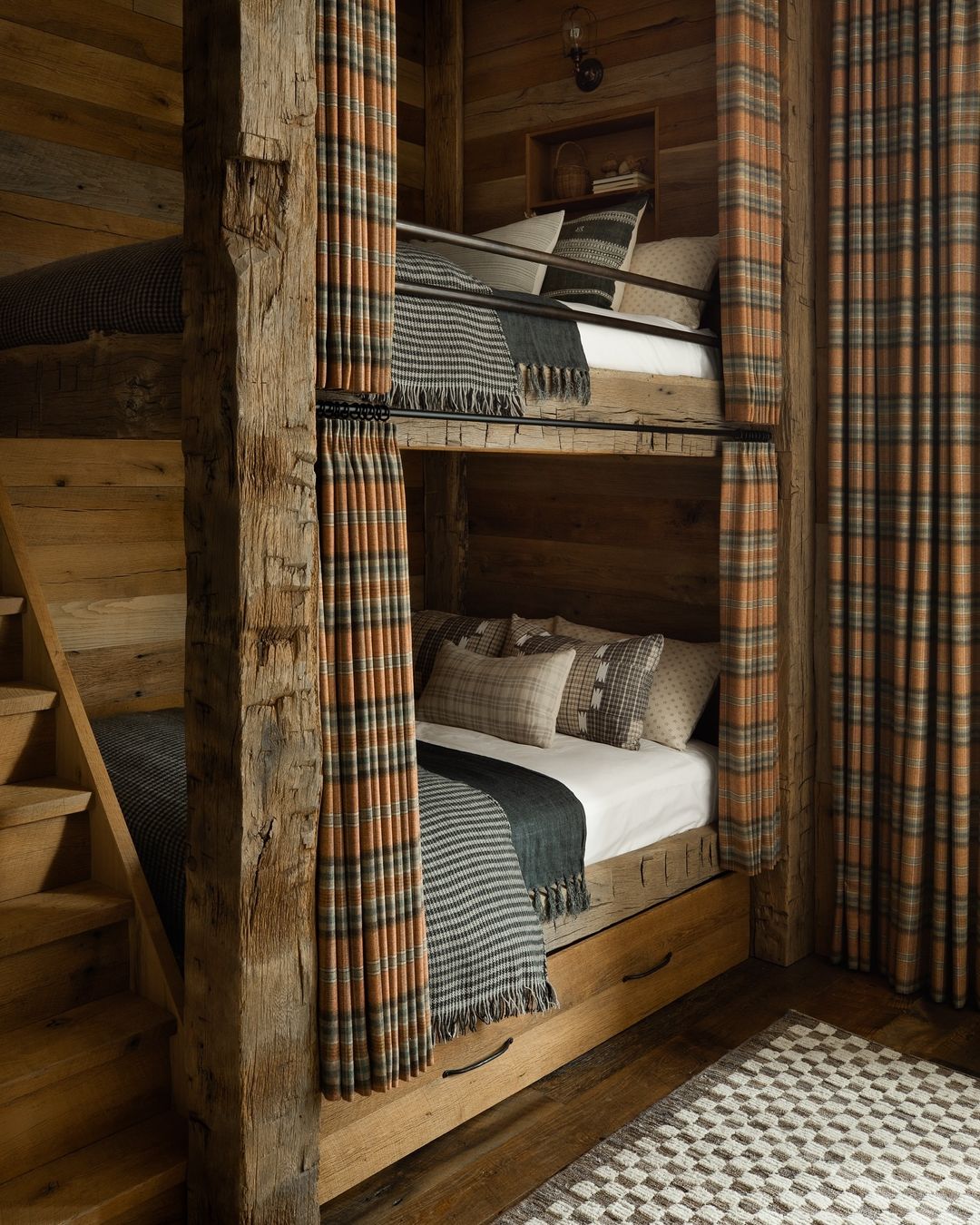 Cozy cabin-style bunk beds with plaid curtains