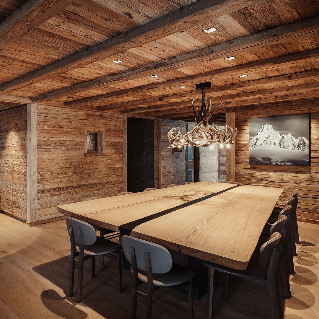 A rustic dining room featuring rich wooden textures and a striking antler chandelier.