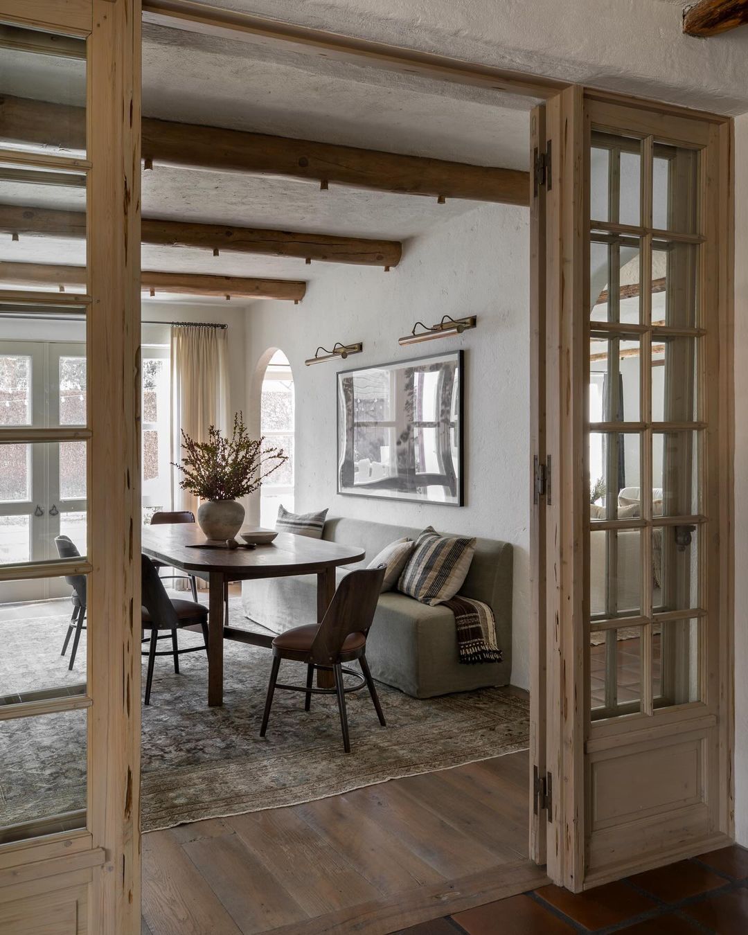 A cozy rustic dining space with wooden elements and natural light