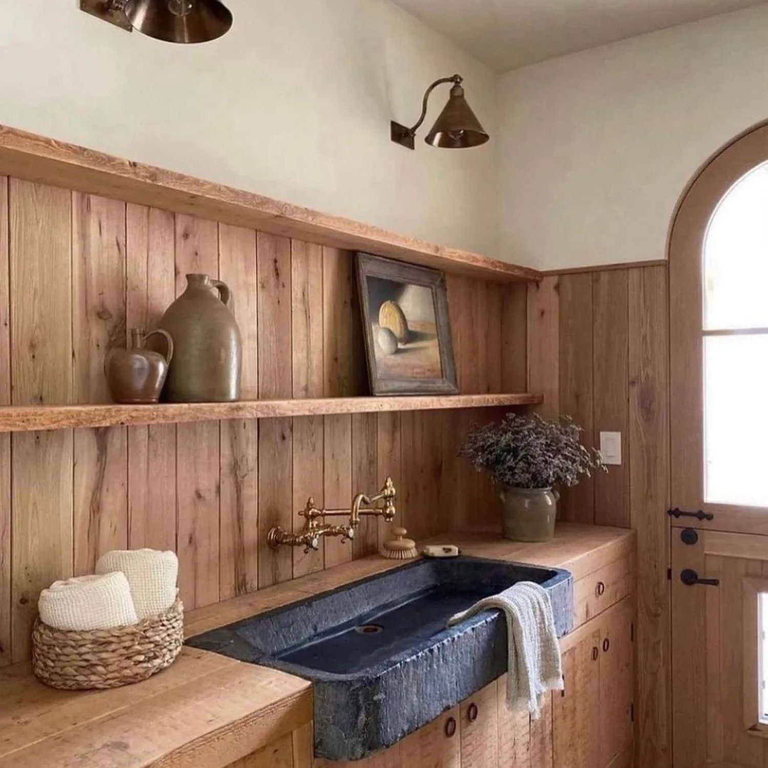 Rustic wooden bathroom with an arched door