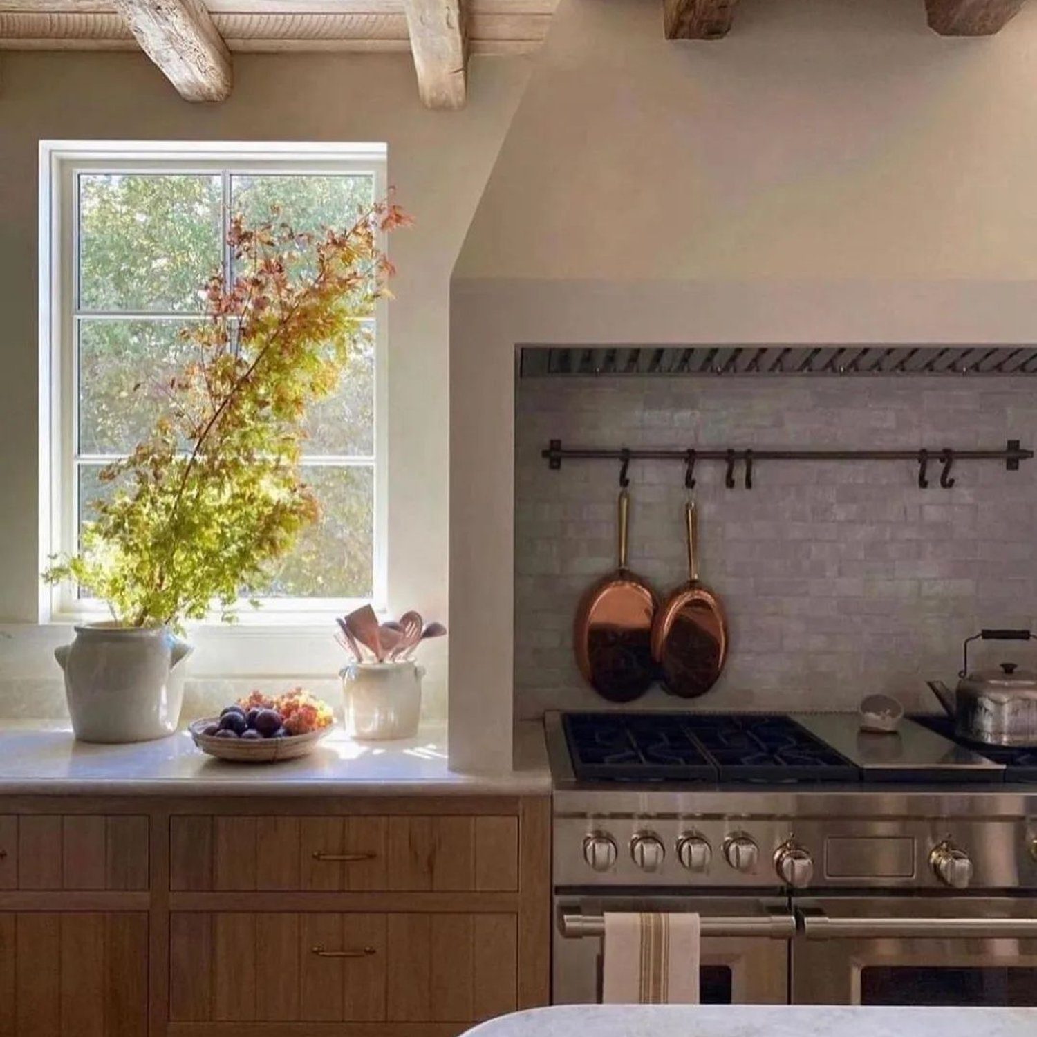 A warm and inviting rustic kitchen featuring exposed wooden beams