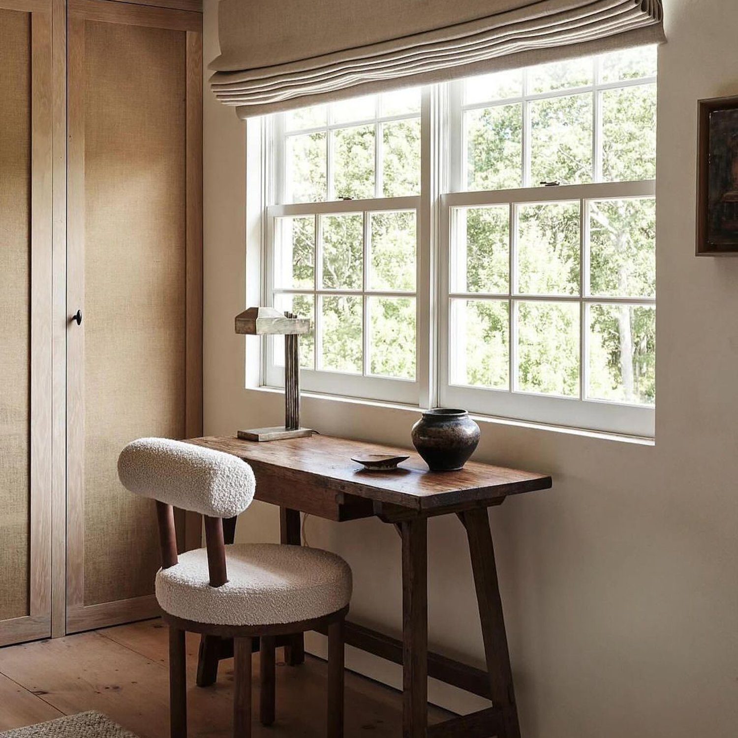 A cozy rustic workspace with a warm natural light pouring in