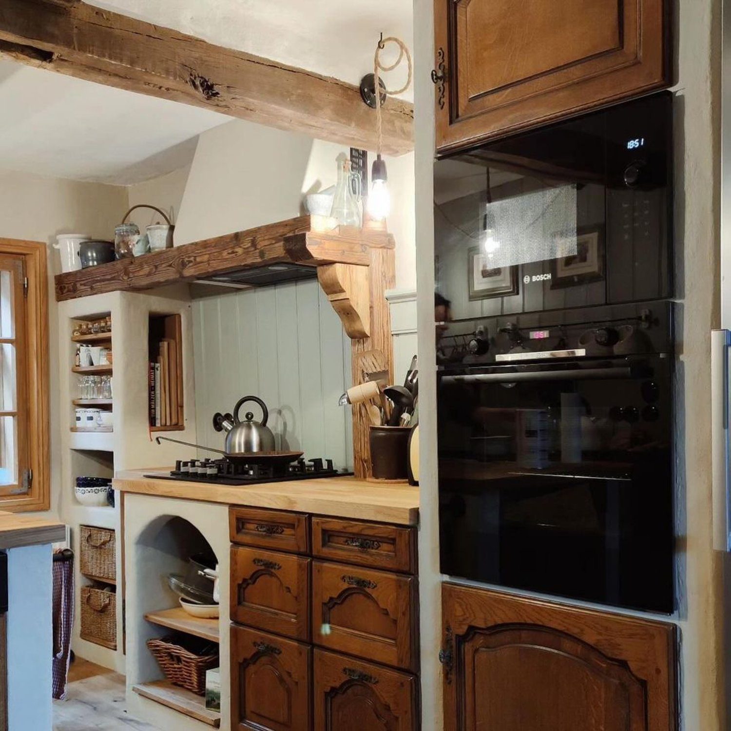 A cozy and rustic kitchen featuring natural wood finishes and vintage style