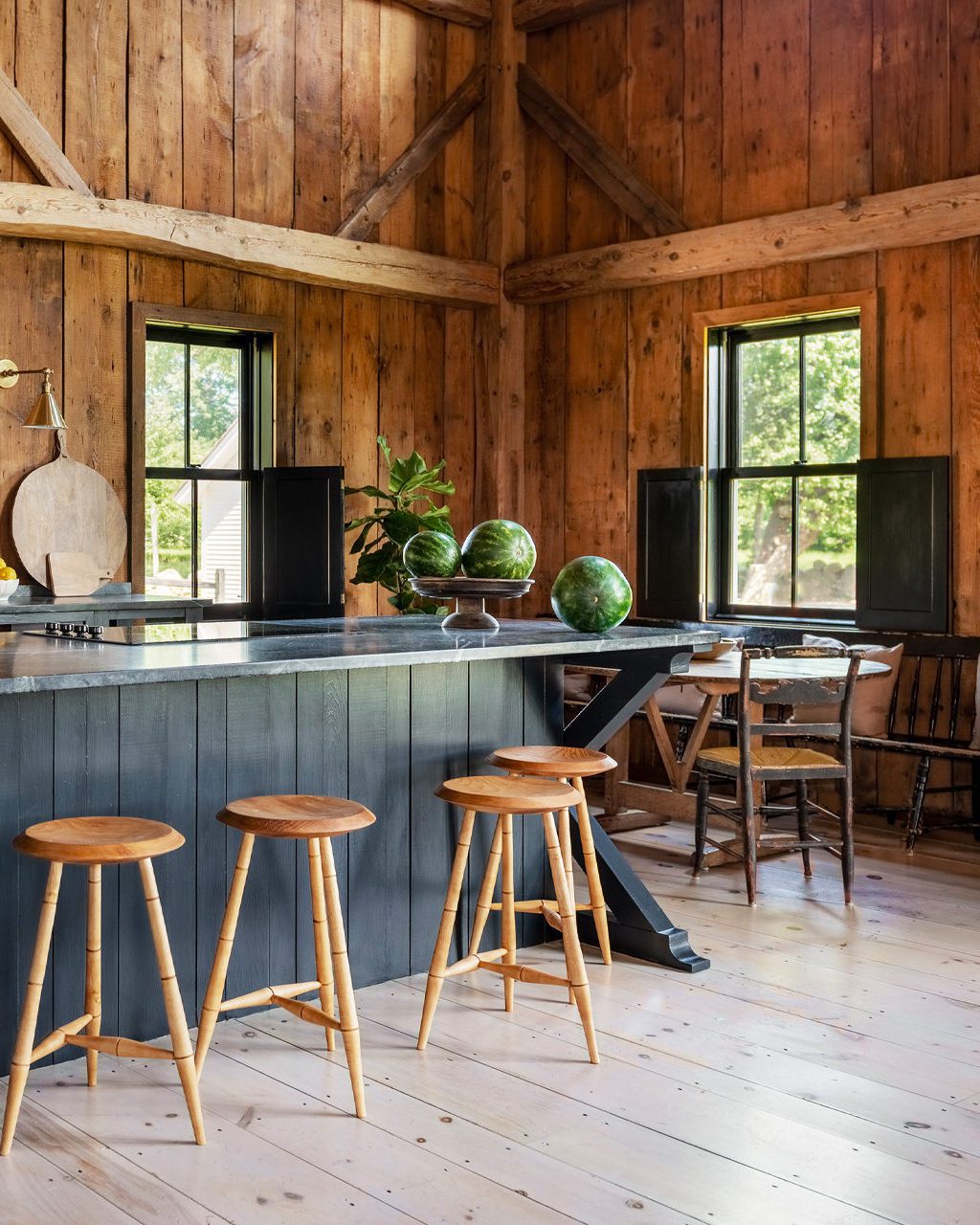 A cozy kitchen interior with warm wooden walls and beams