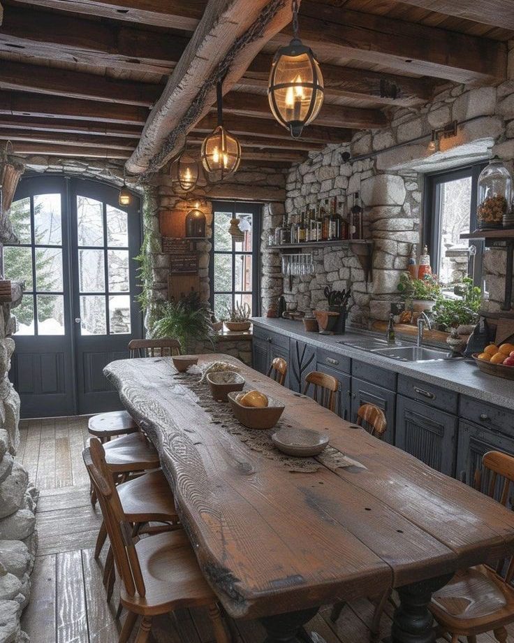 Rustic kitchen with a long wooden table and stone accents