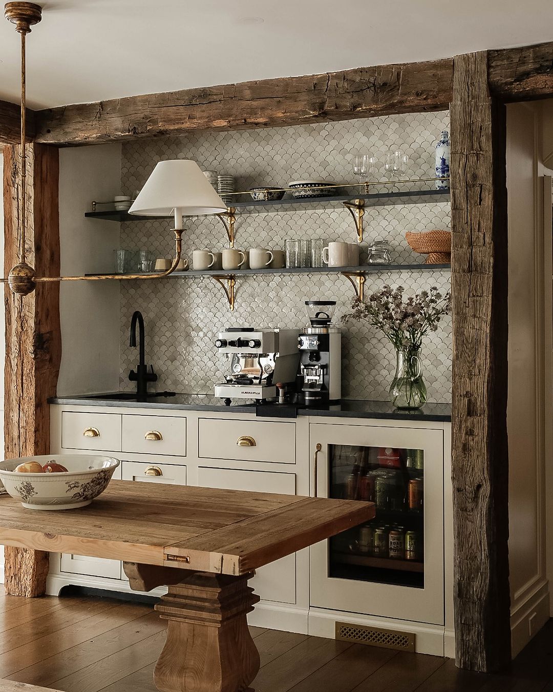 Rustic kitchen with exposed wooden beams and modern appliances