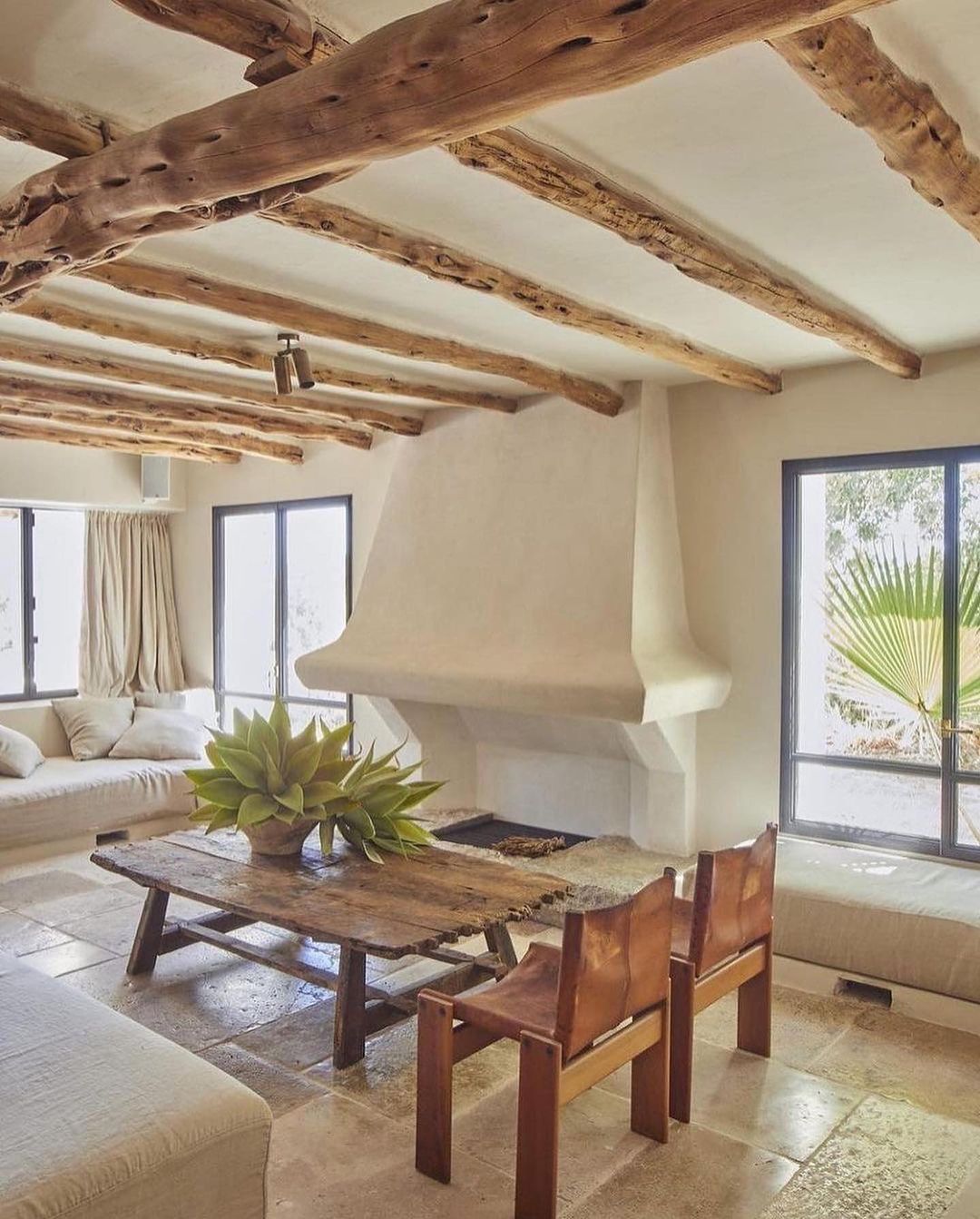 A rustic living room featuring exposed wooden beams