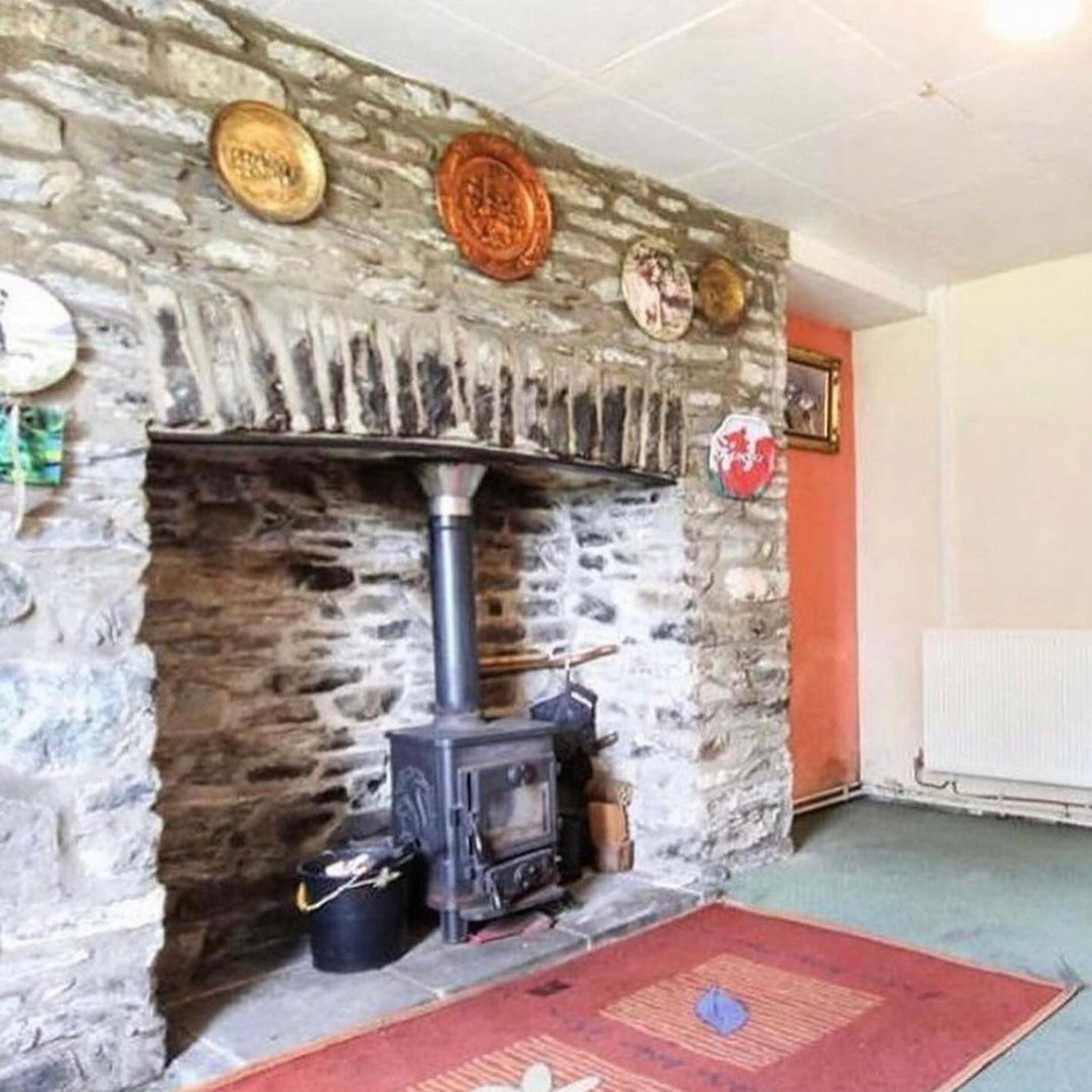 A charming rustic living room featuring a stone fireplace