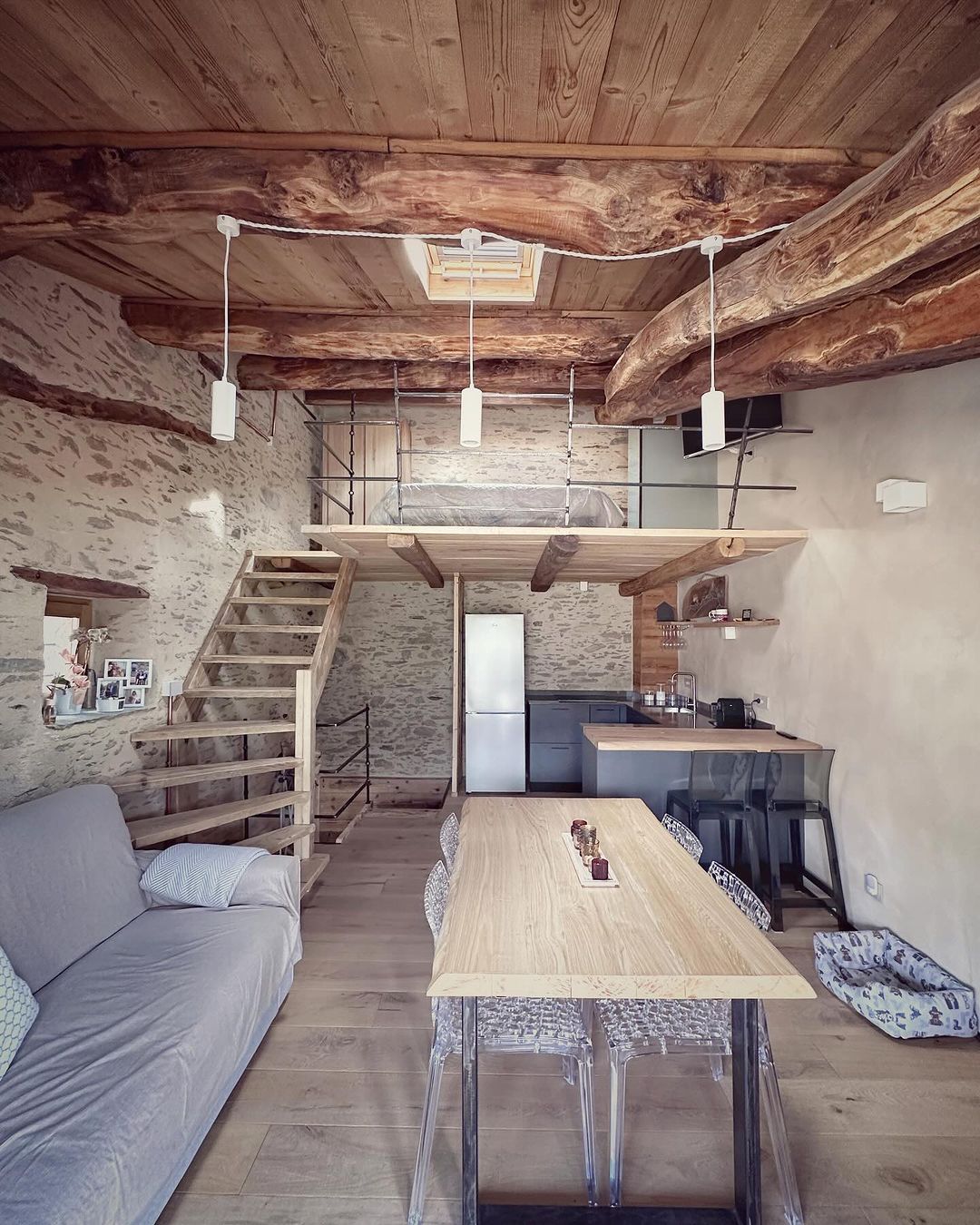 A cozy and rustic living room with exposed wooden beams