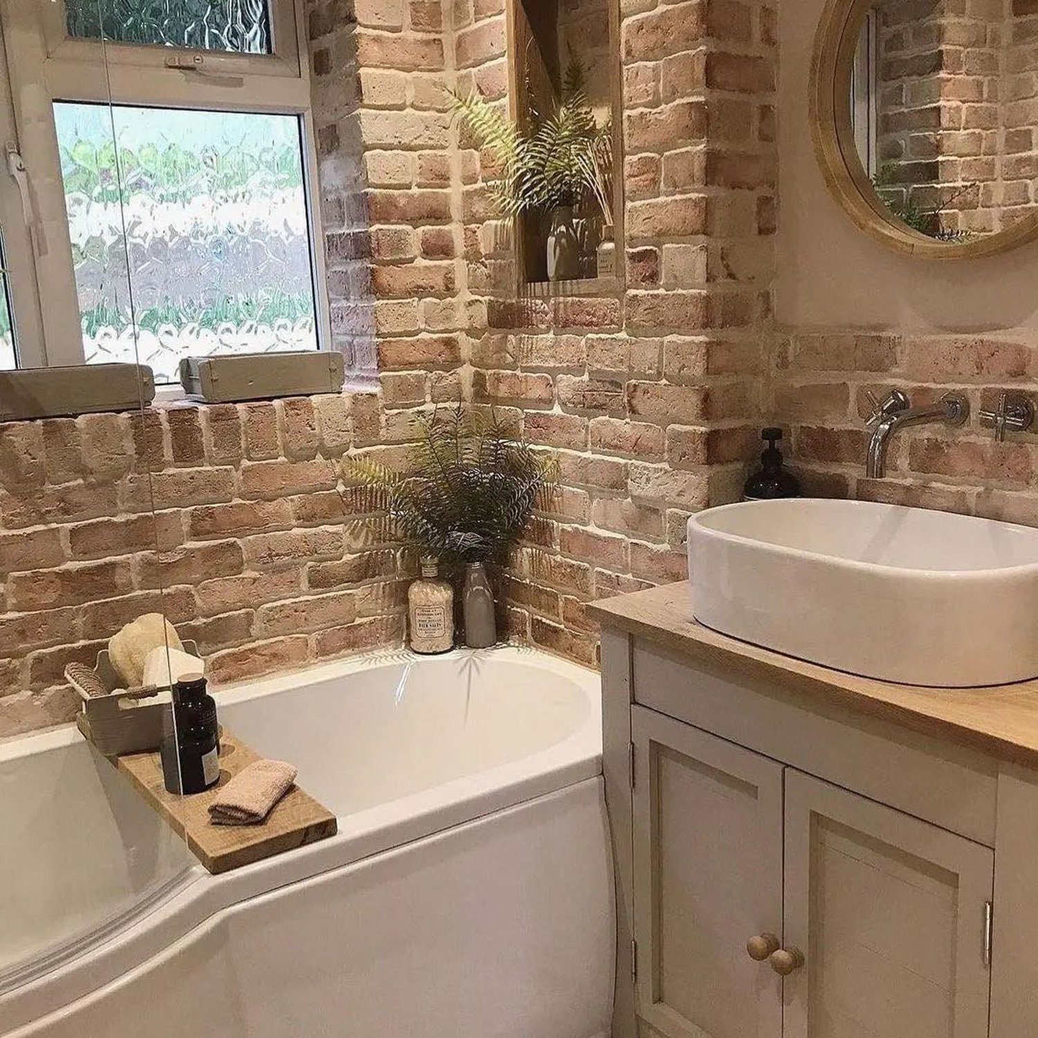 A rustic yet modern bathroom with exposed brick walls and contemporary fixtures