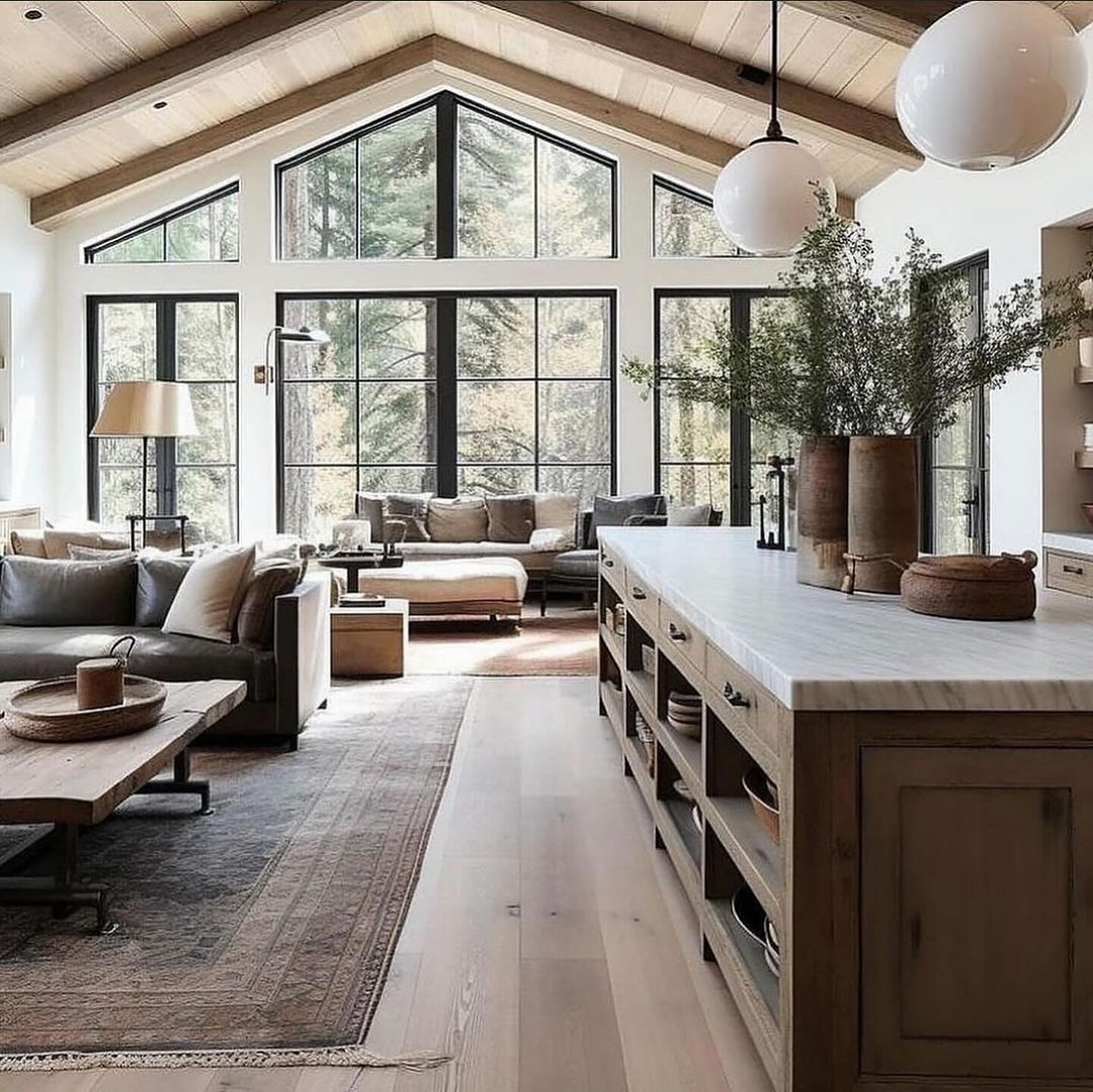 A rustic modern kitchen with towering windows