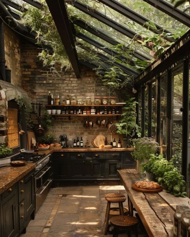 A rustic yet modern kitchen conservatory with a full glass ceiling and stone floor