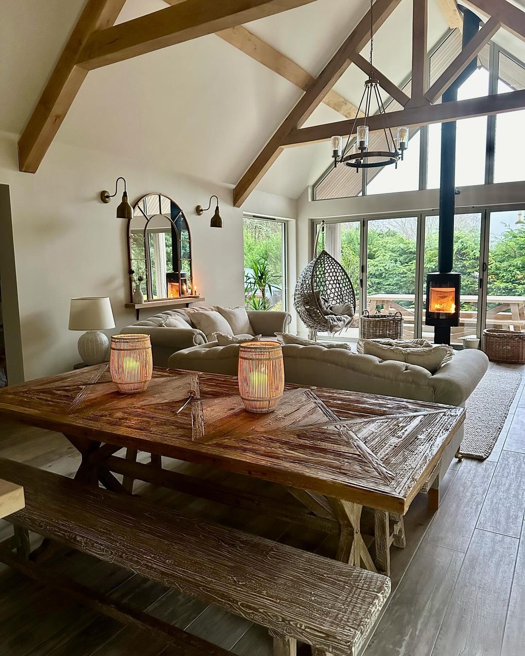 A rustic yet modern living room with exposed wooden beams and cozy fireplace