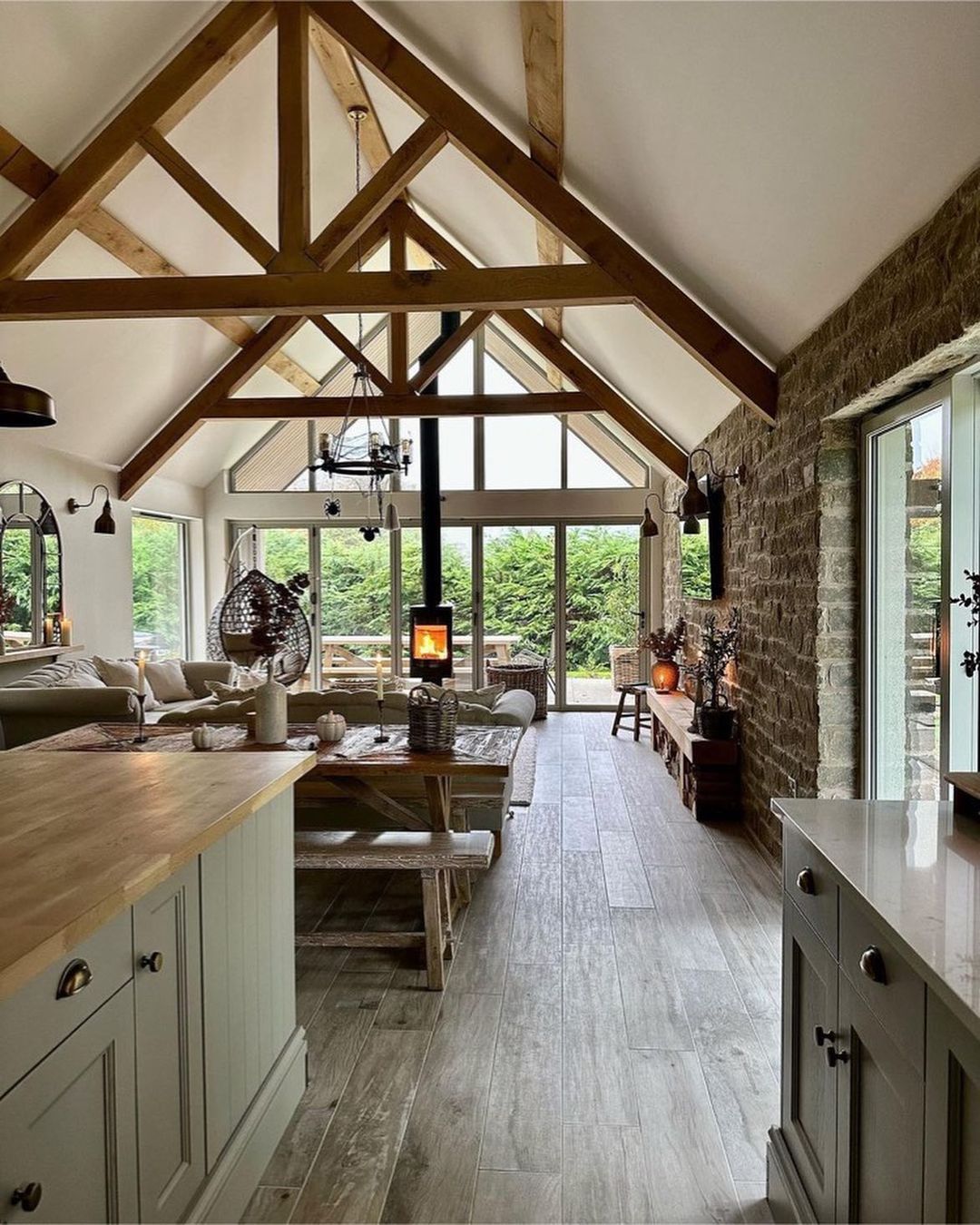 A rustic-style kitchen merges seamlessly into a cozy living room space