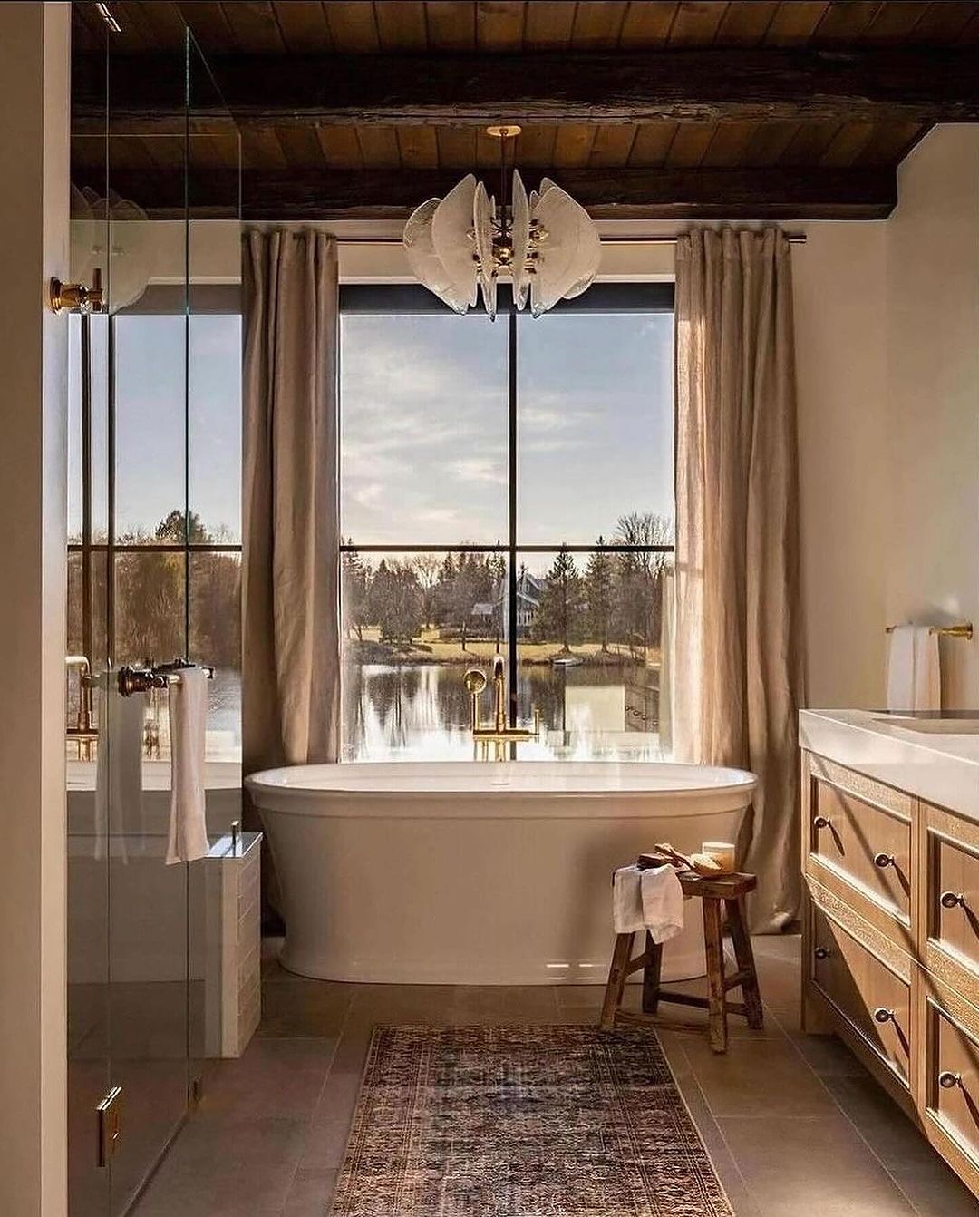 A serene bathroom overlooking a peaceful lake