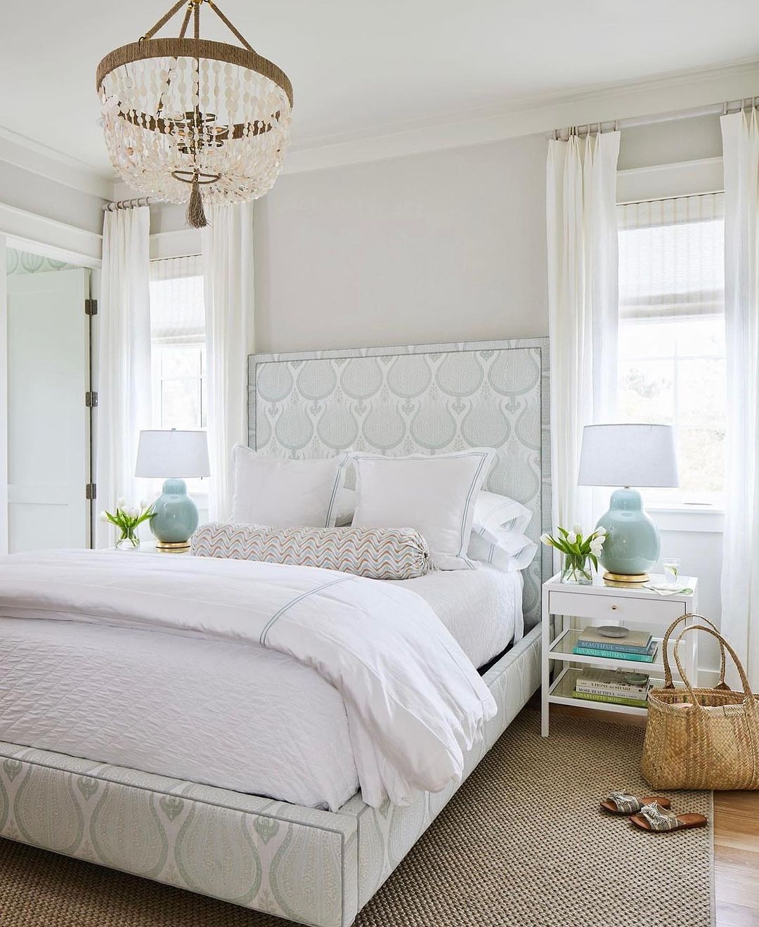 A serene bedroom design featuring a patterned headboard, soft color palette, and natural textures