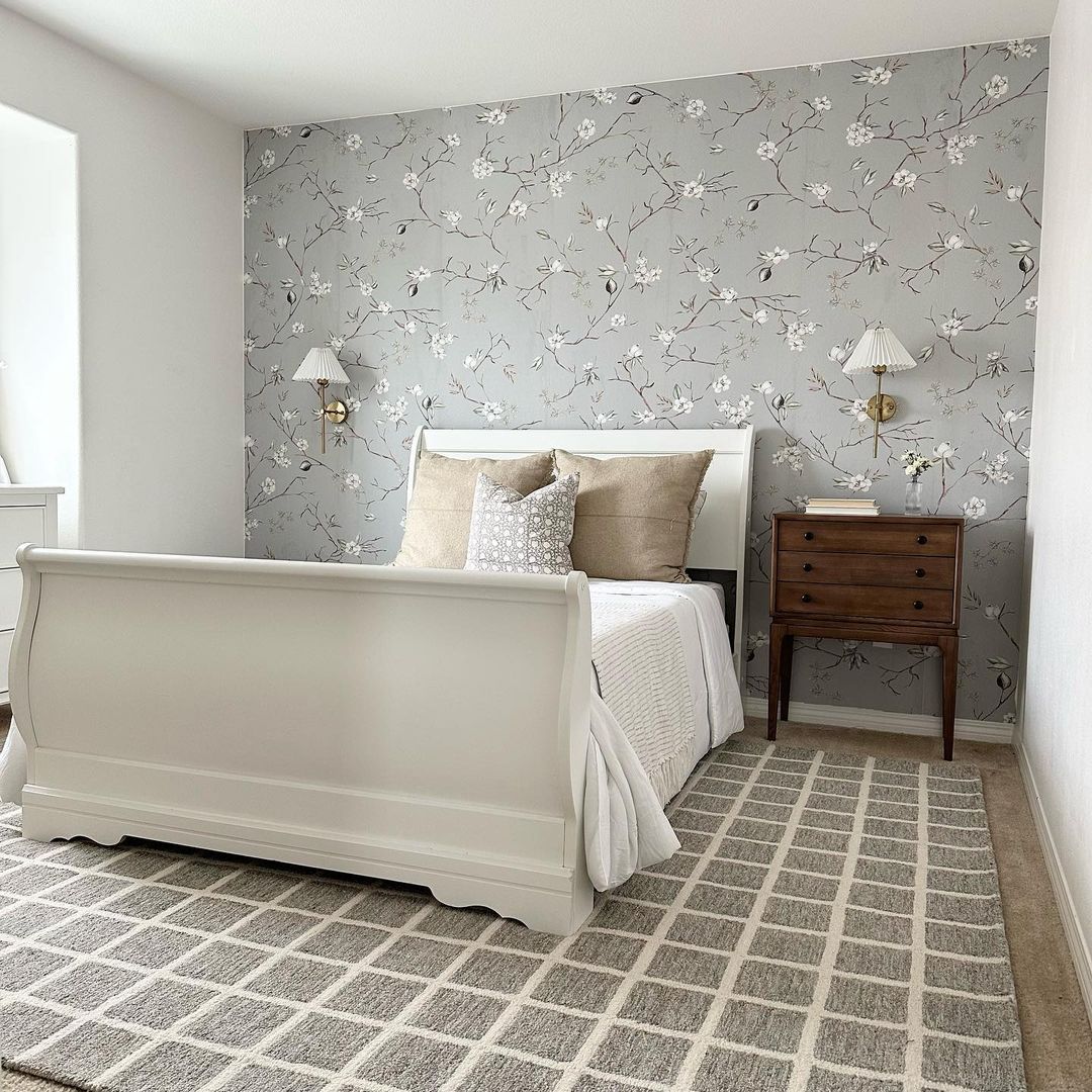 A serene and stylish bedroom with floral wallpaper and classic furniture