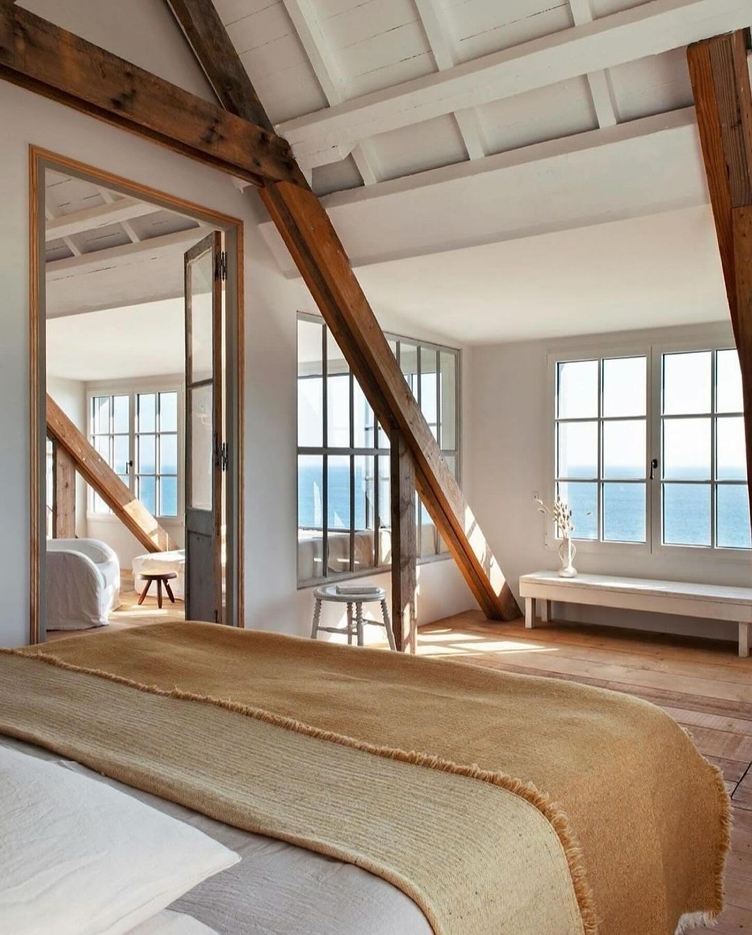 A serene and rustic bedroom overlooking the ocean