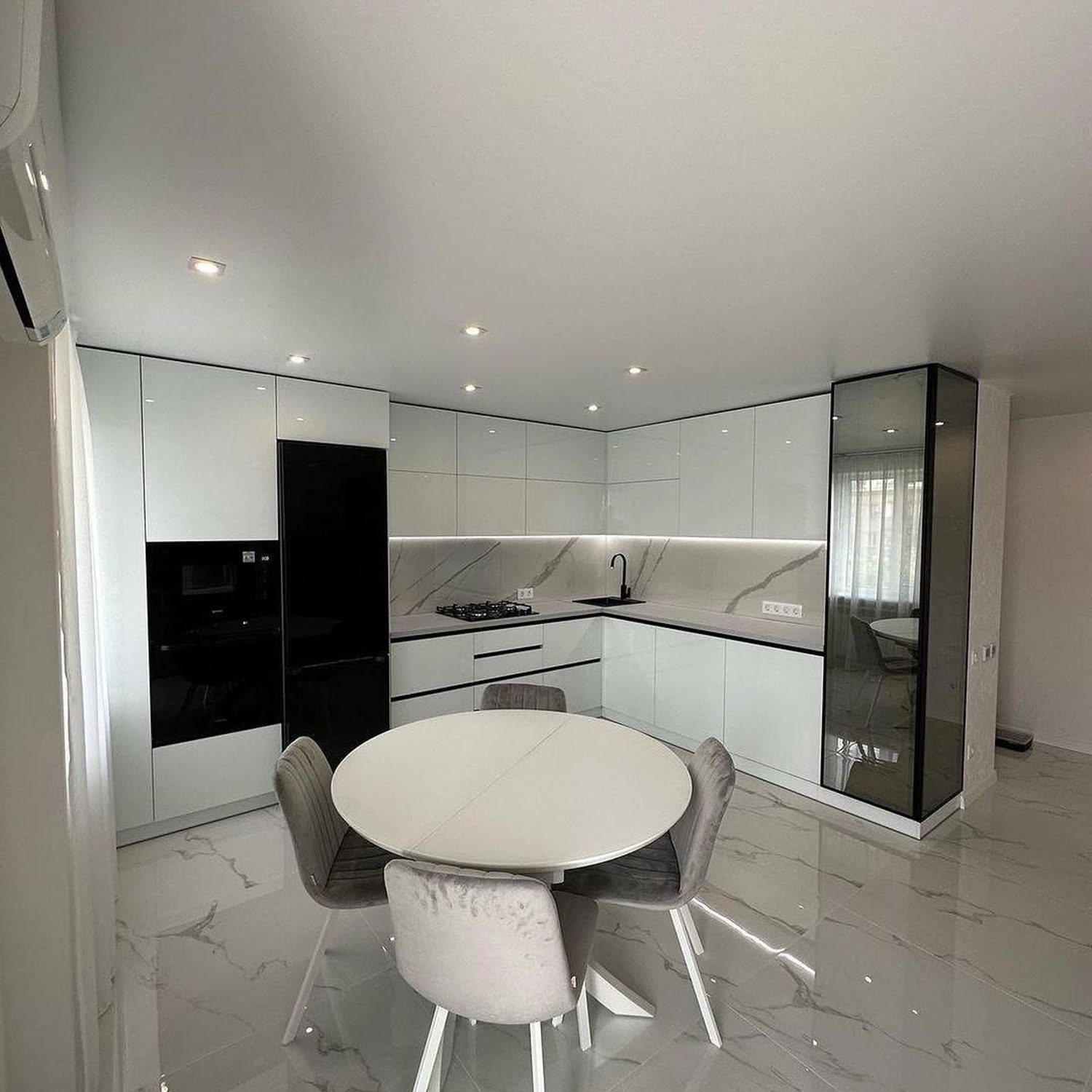 A sleek and modern kitchen with reflective surfaces and a minimalist design