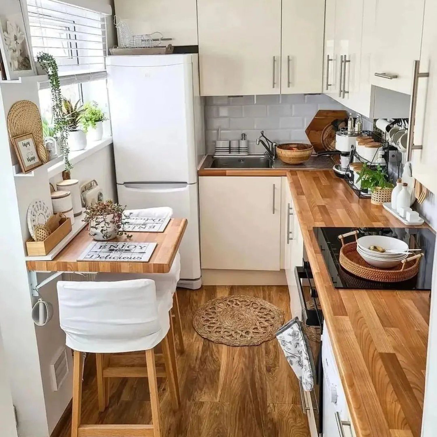 A cozy and efficient small kitchen with light wood countertops and white cabinetry, featuring a compact design optimized for space.