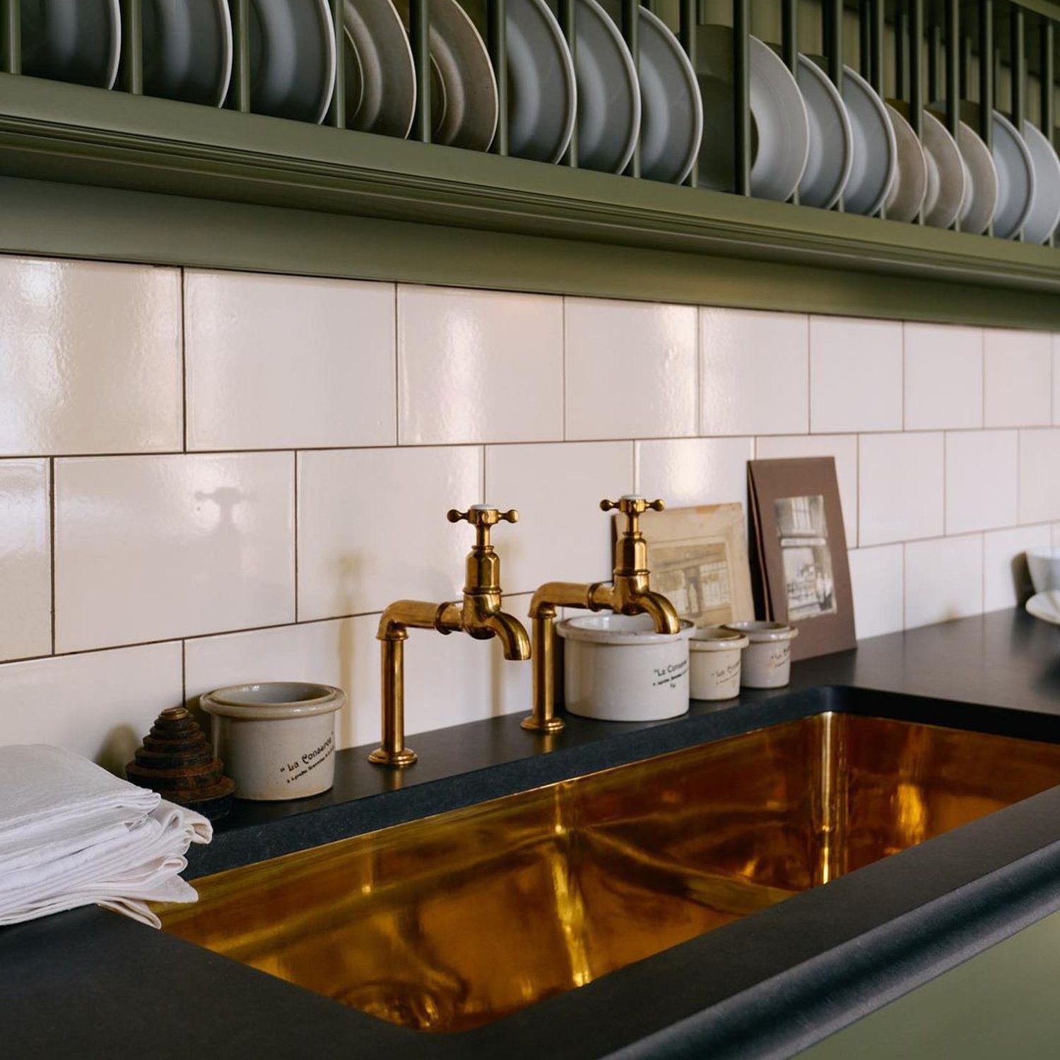 A sophisticated kitchen sink with brass faucets