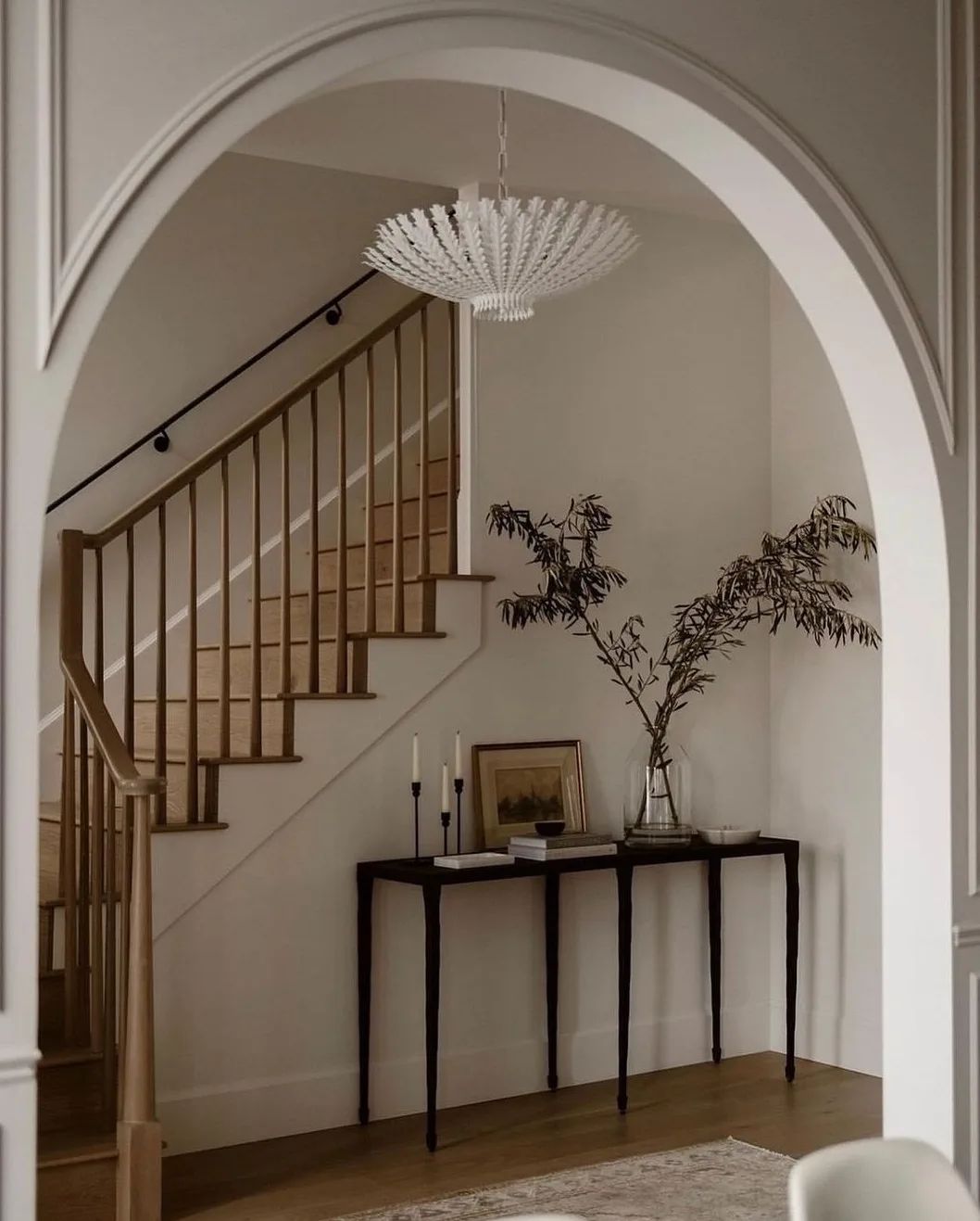 A harmoniously designed entryway with arched doorway