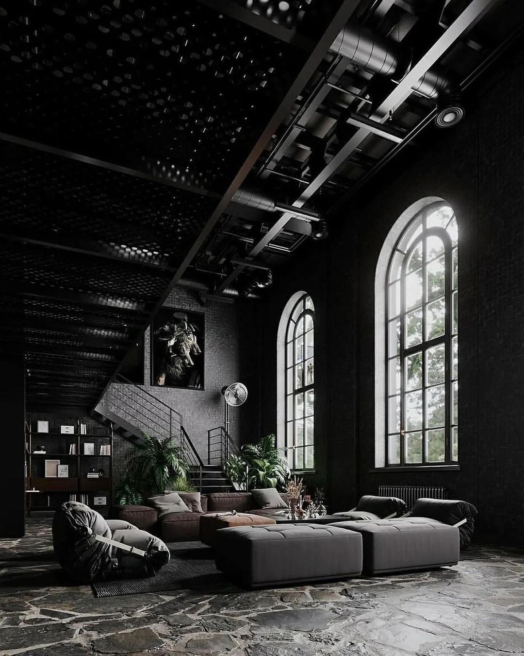 Loft-style living space with high ceilings and arched windows