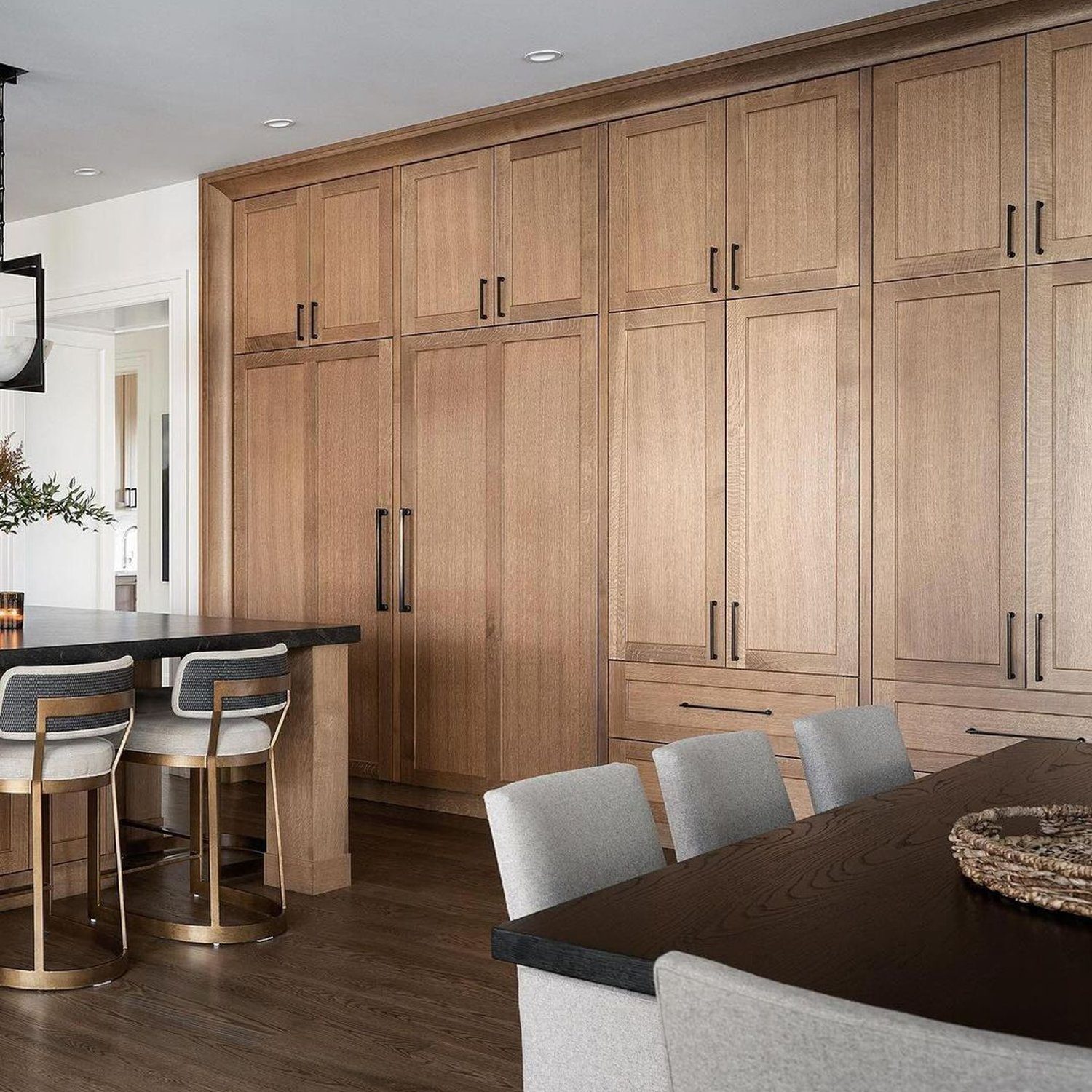 A modern kitchen featuring seamless wood cabinetry and a sleek design